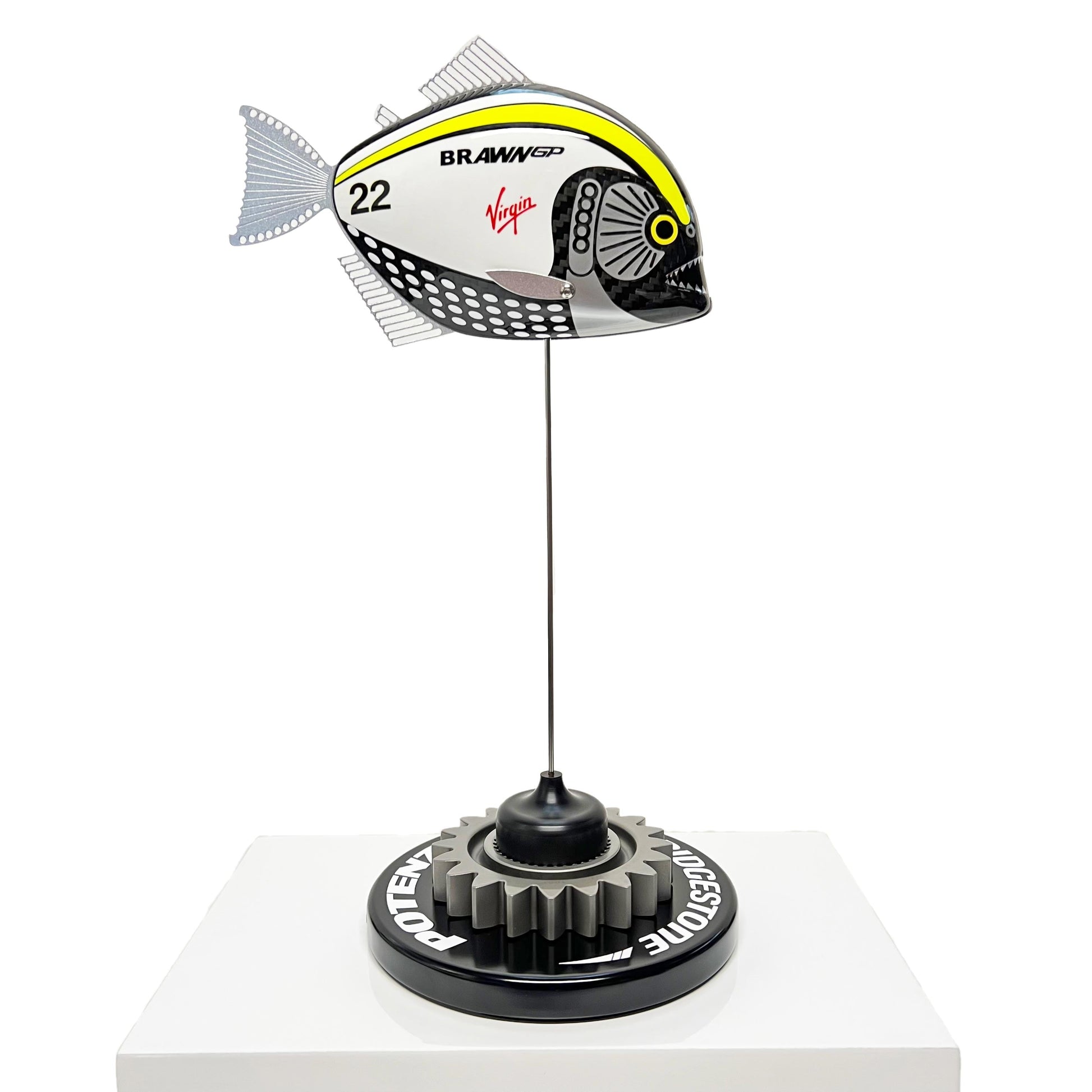Carbon fibre piranha sculpture with Brawn GP livery on a black base with F1 gear