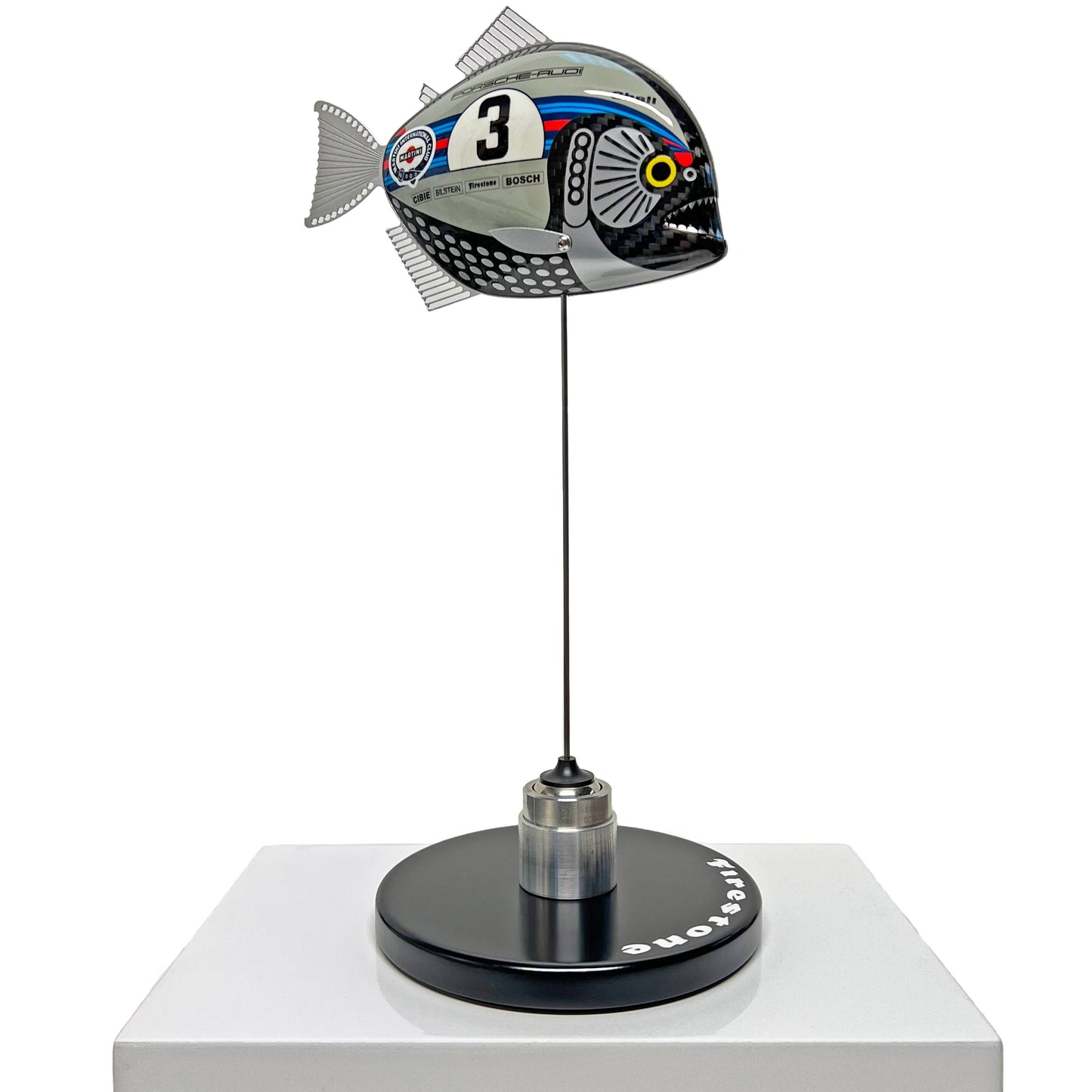 Carbon fibre Piranha sculpture with Martini Porsche livery on a black base with F1 parts