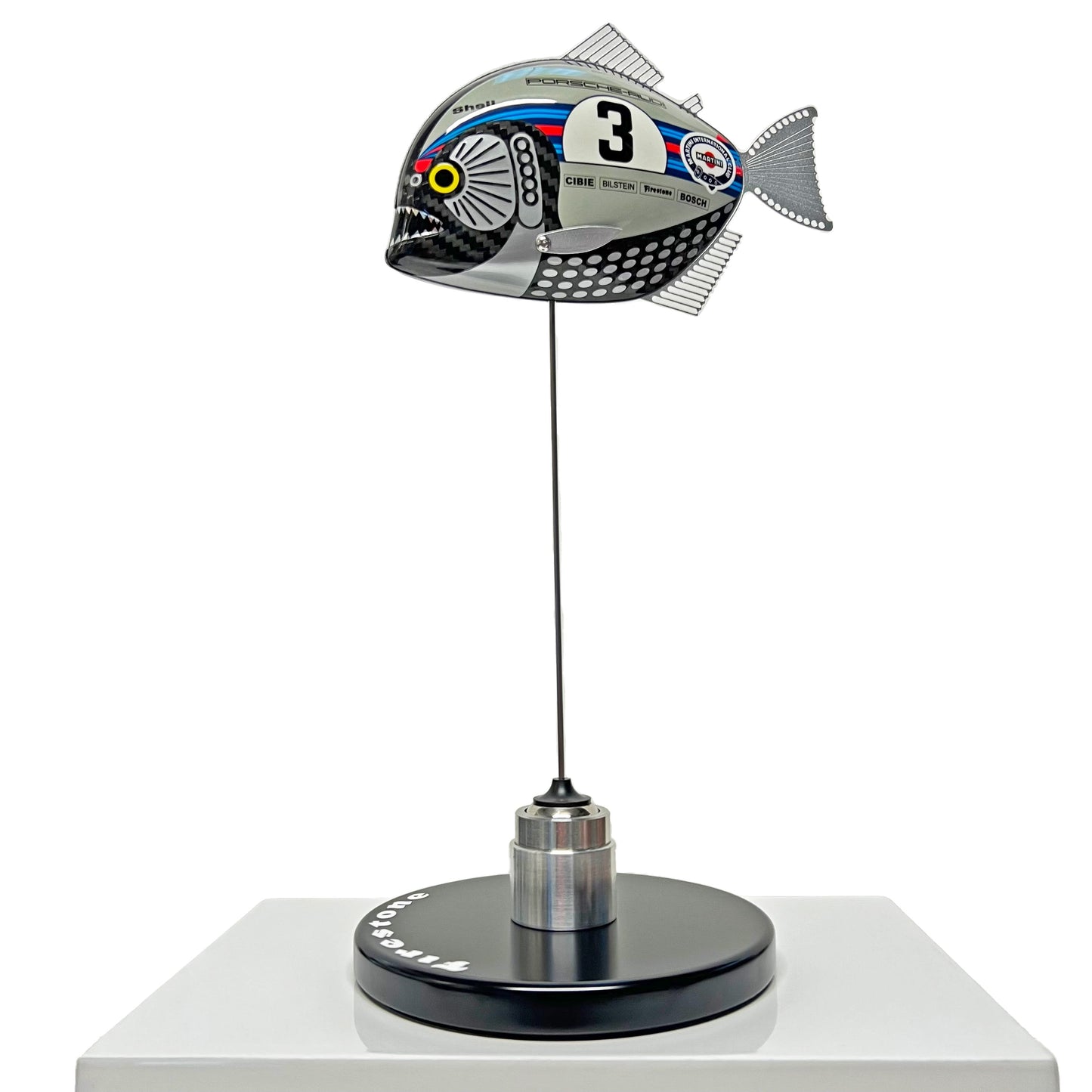 Carbon fibre Piranha sculpture with Martini Porsche livery on a black base with F1 parts