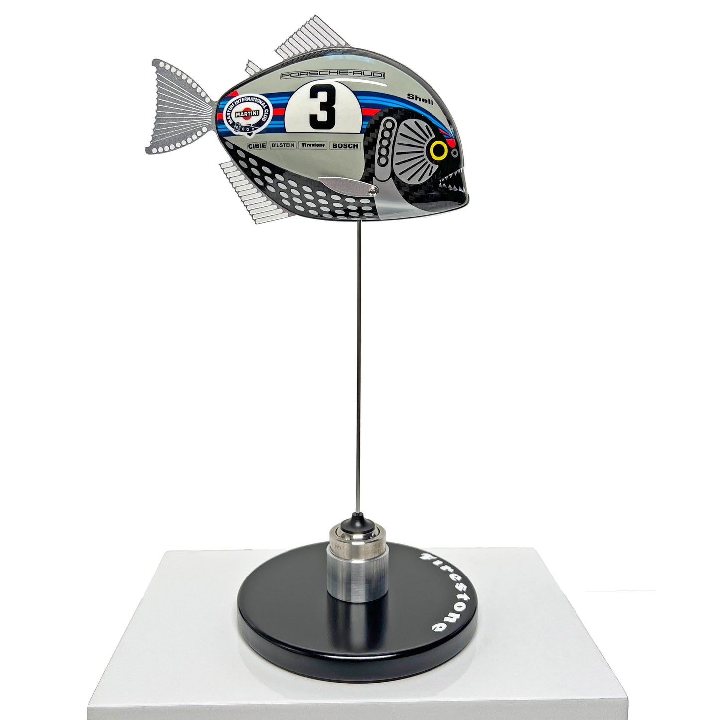 Carbon fibre Piranha sculpture with Martini Porsche livery on a black base with F1 parts