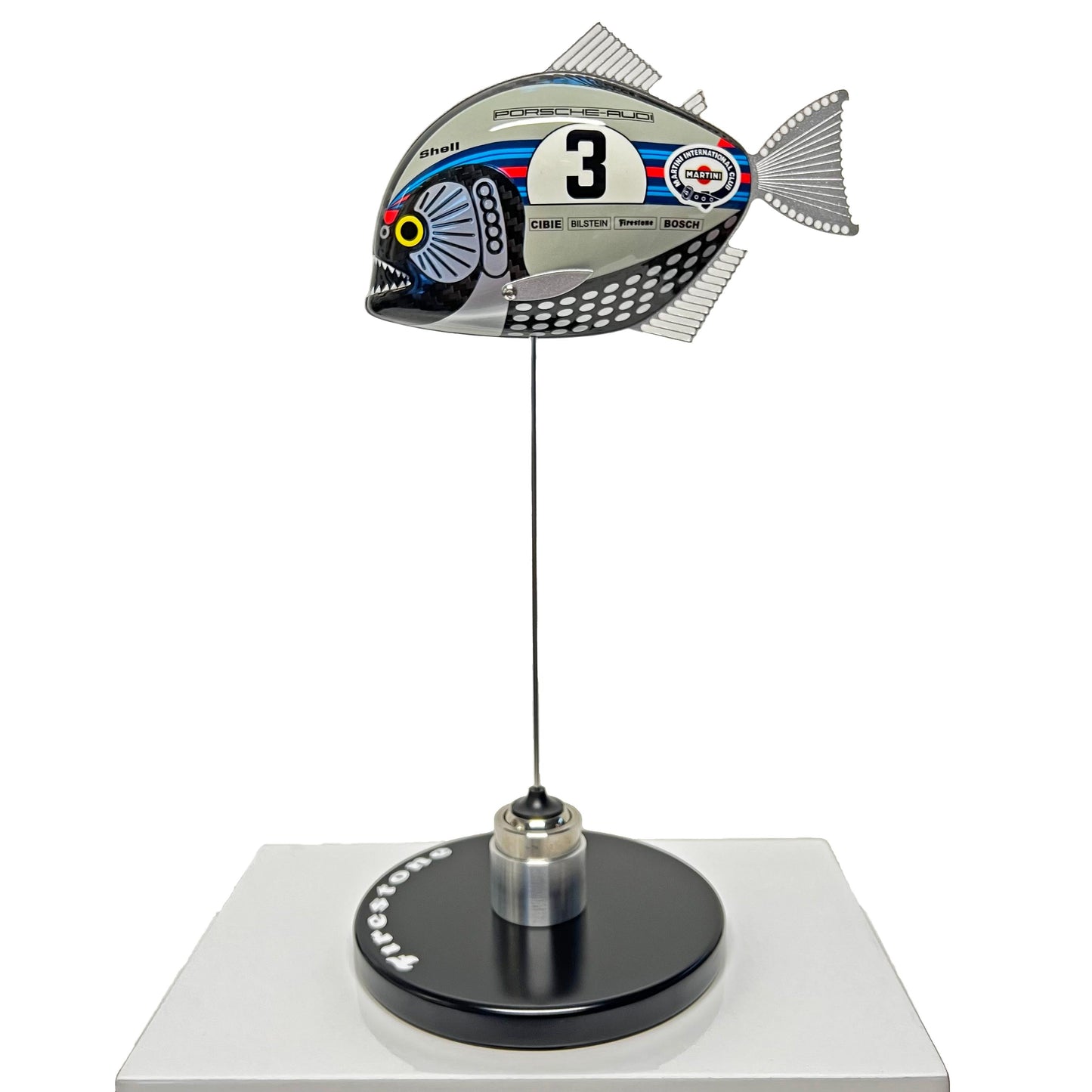 Carbon fibre Piranha sculpture with Martini Porsche livery on a black base with F1 parts