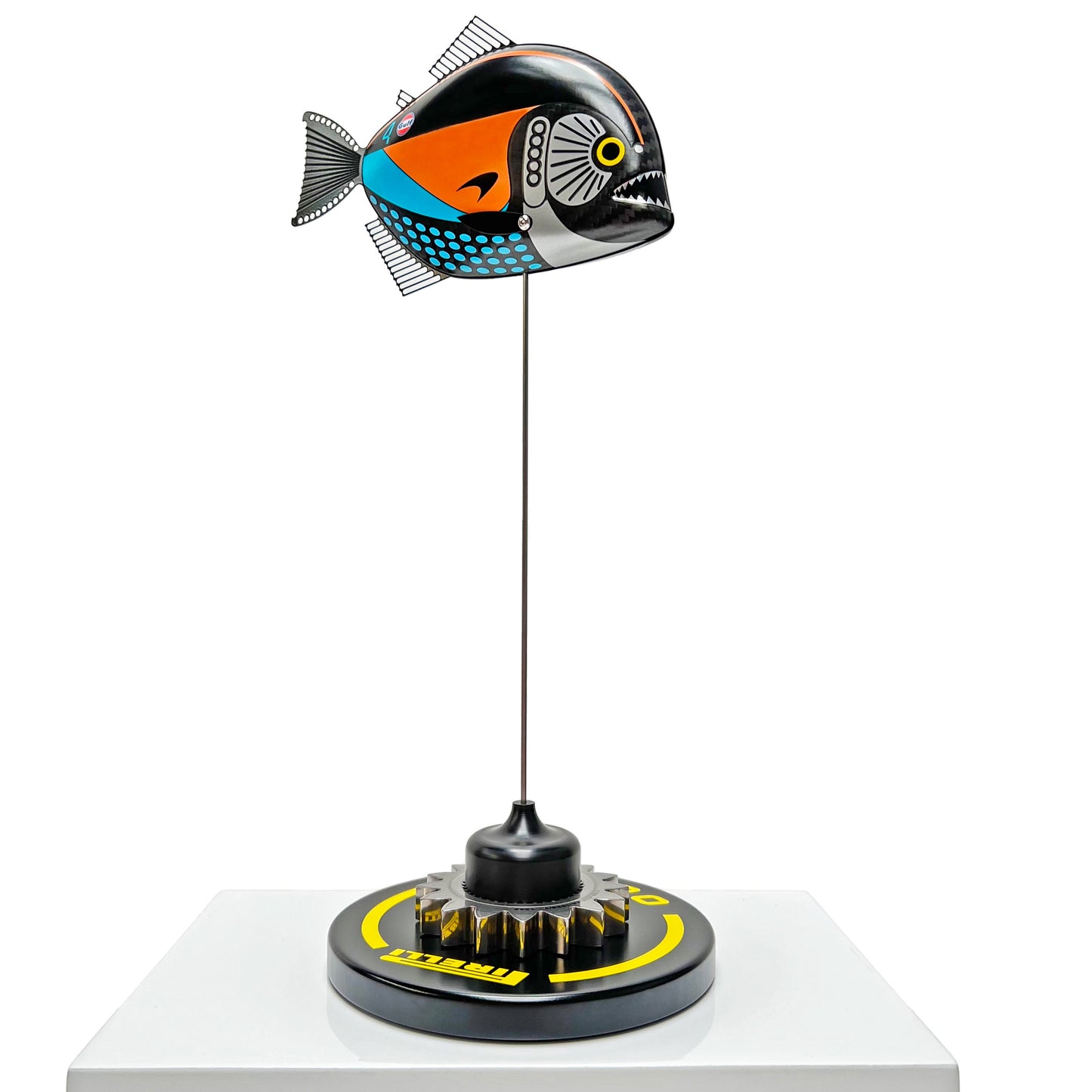 Carbon fibre Piranha sculpture with McLaren livery on a black base with F1 gear