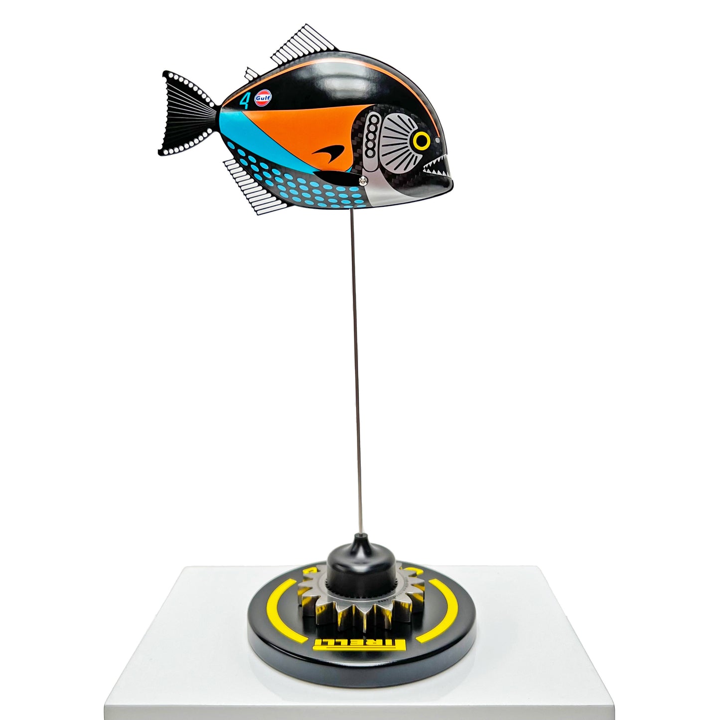 Carbon fibre Piranha sculpture with McLaren livery on a black base with F1 gear