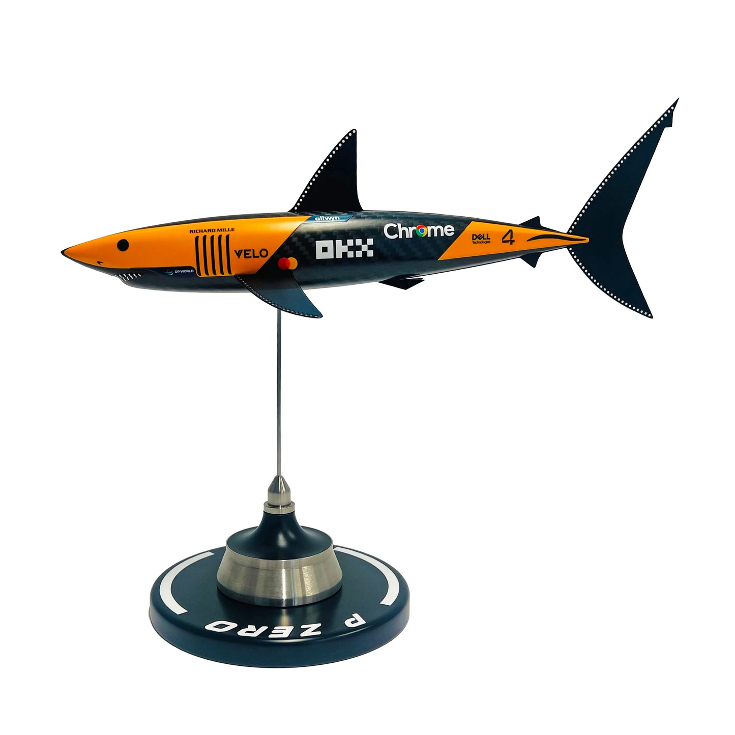 Carbon fibre sculpture of a shark with McLaren F1 branding on a white background