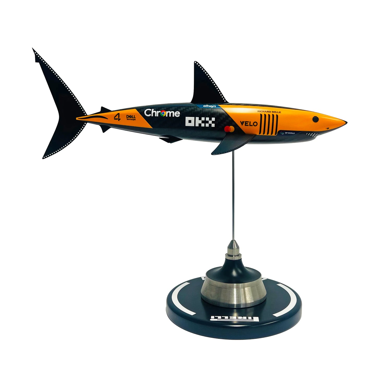 Carbon fibre sculpture of a shark with McLaren F1 branding on a white background