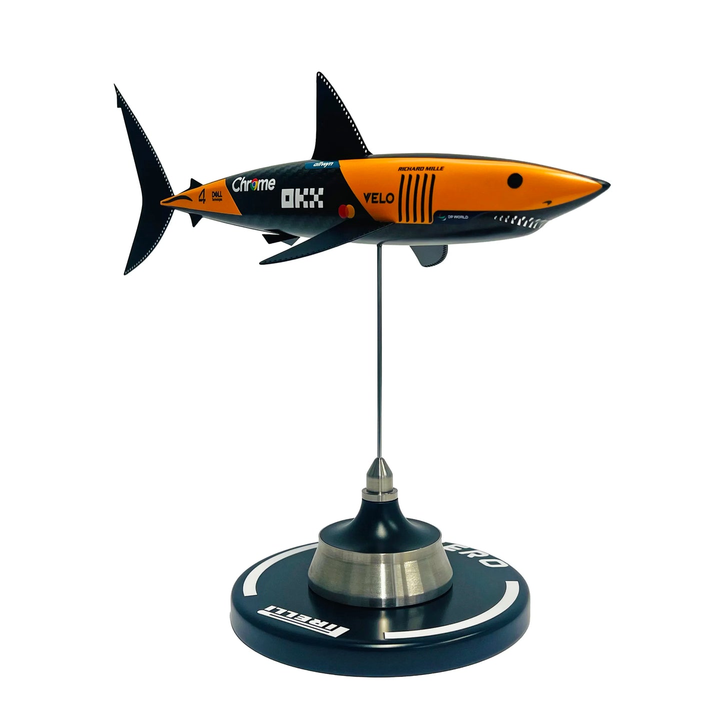 Carbon fibre sculpture of a shark with McLaren F1 branding on a white background