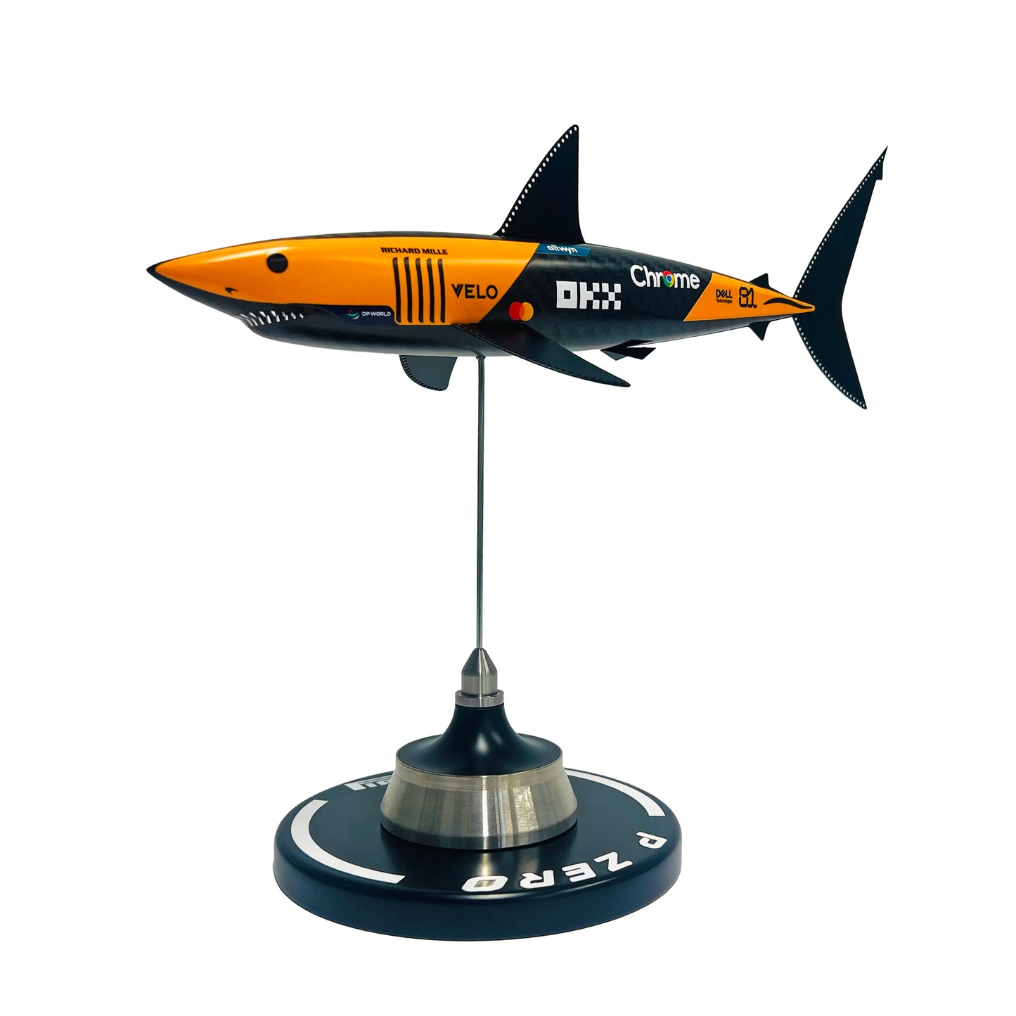 Carbon fibre sculpture of a shark with McLaren F1 branding on a white background