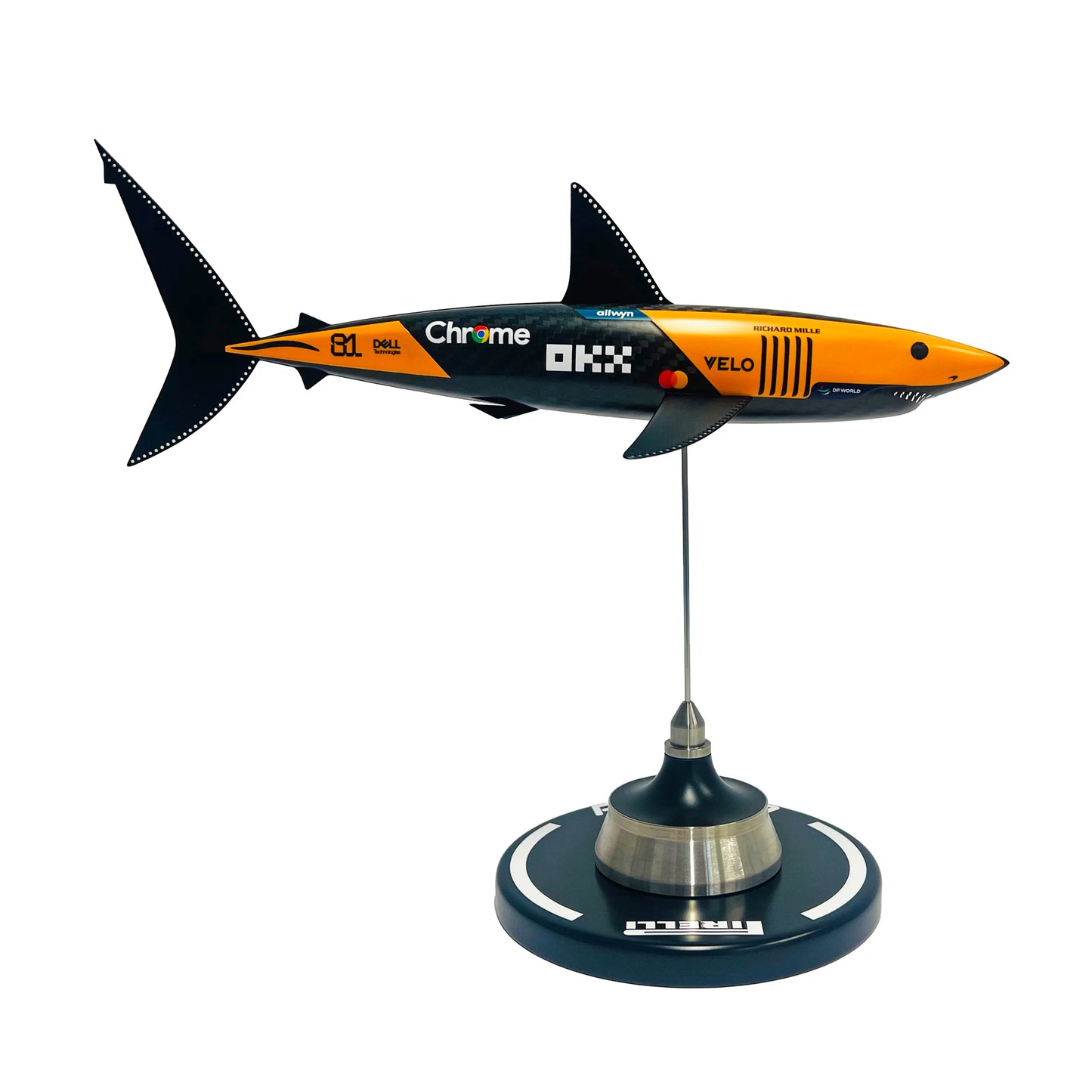 Carbon fibre sculpture of a shark with McLaren F1 branding on a white background