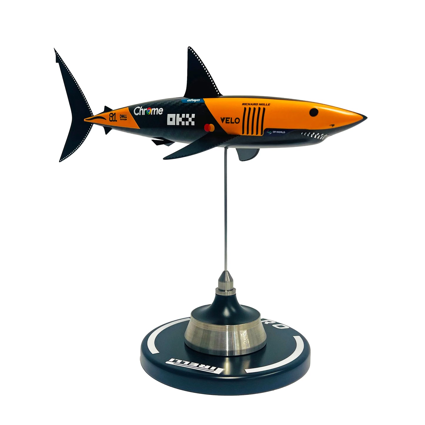 Carbon fibre sculpture of a shark with McLaren F1 branding on a white background
