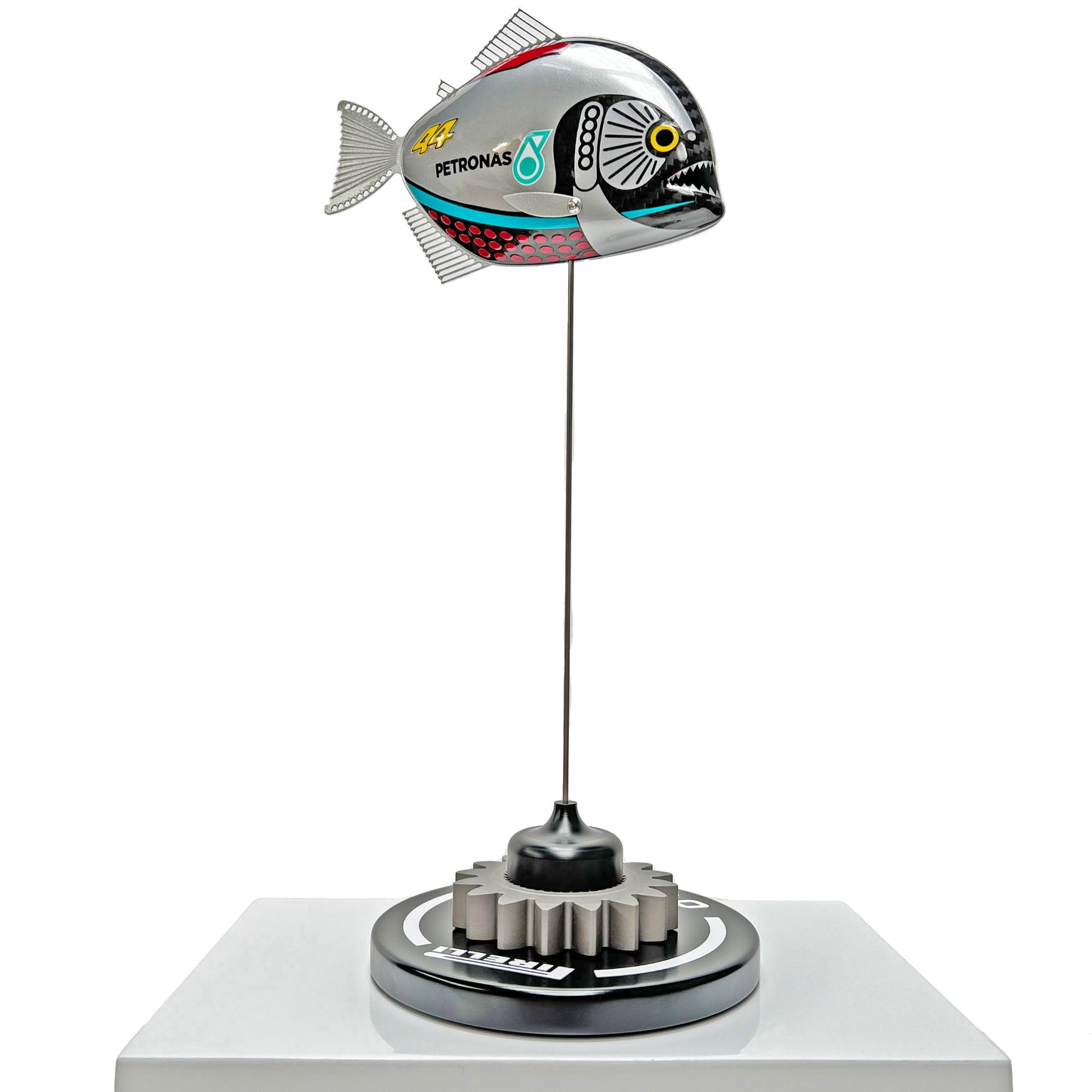 Carbon fibre piranha sculpture with Mercedes livery on a black base with F1 gear