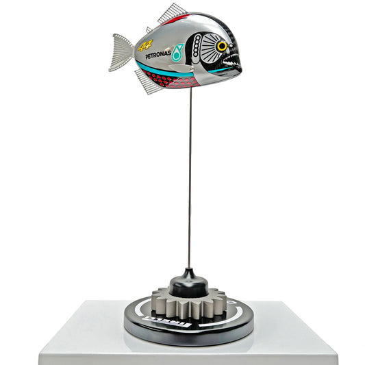 Carbon fibre piranha sculpture with Mercedes livery on a black base with F1 gear
