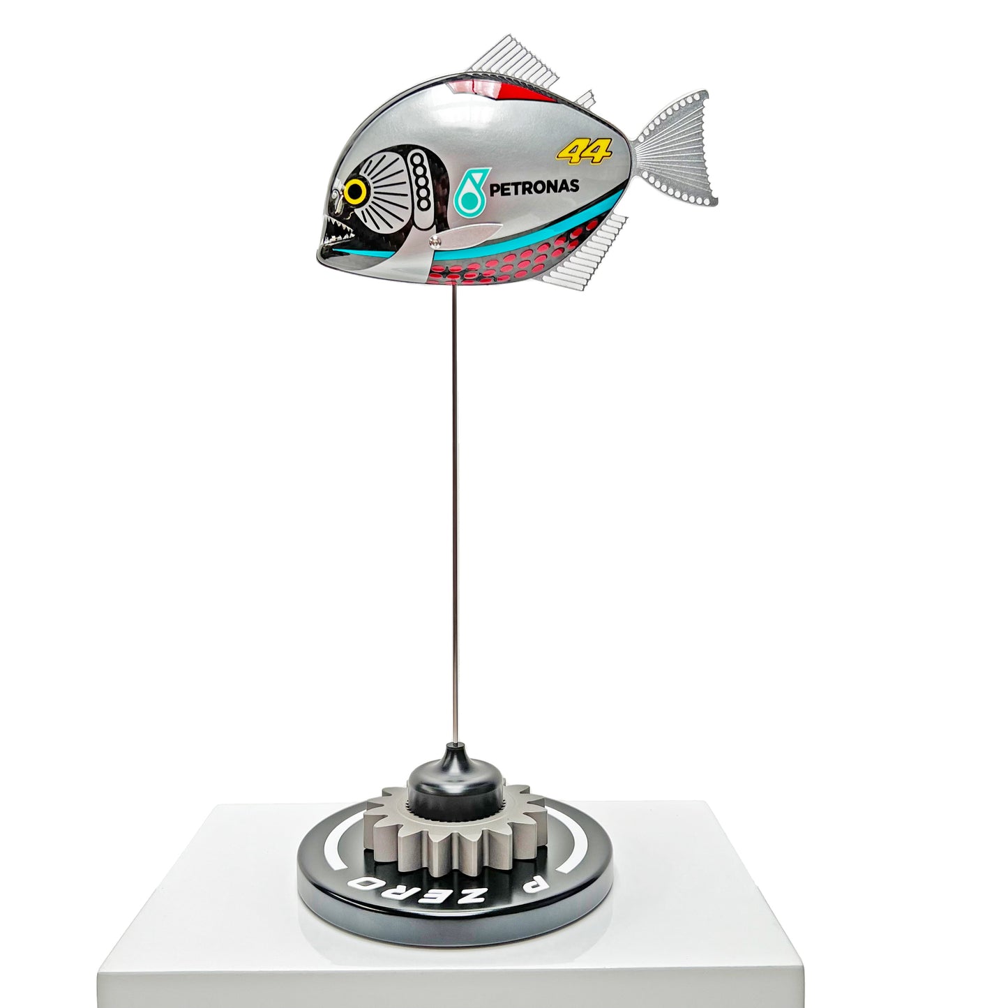 Carbon fibre piranha sculpture with Mercedes livery on a black base with F1 gear