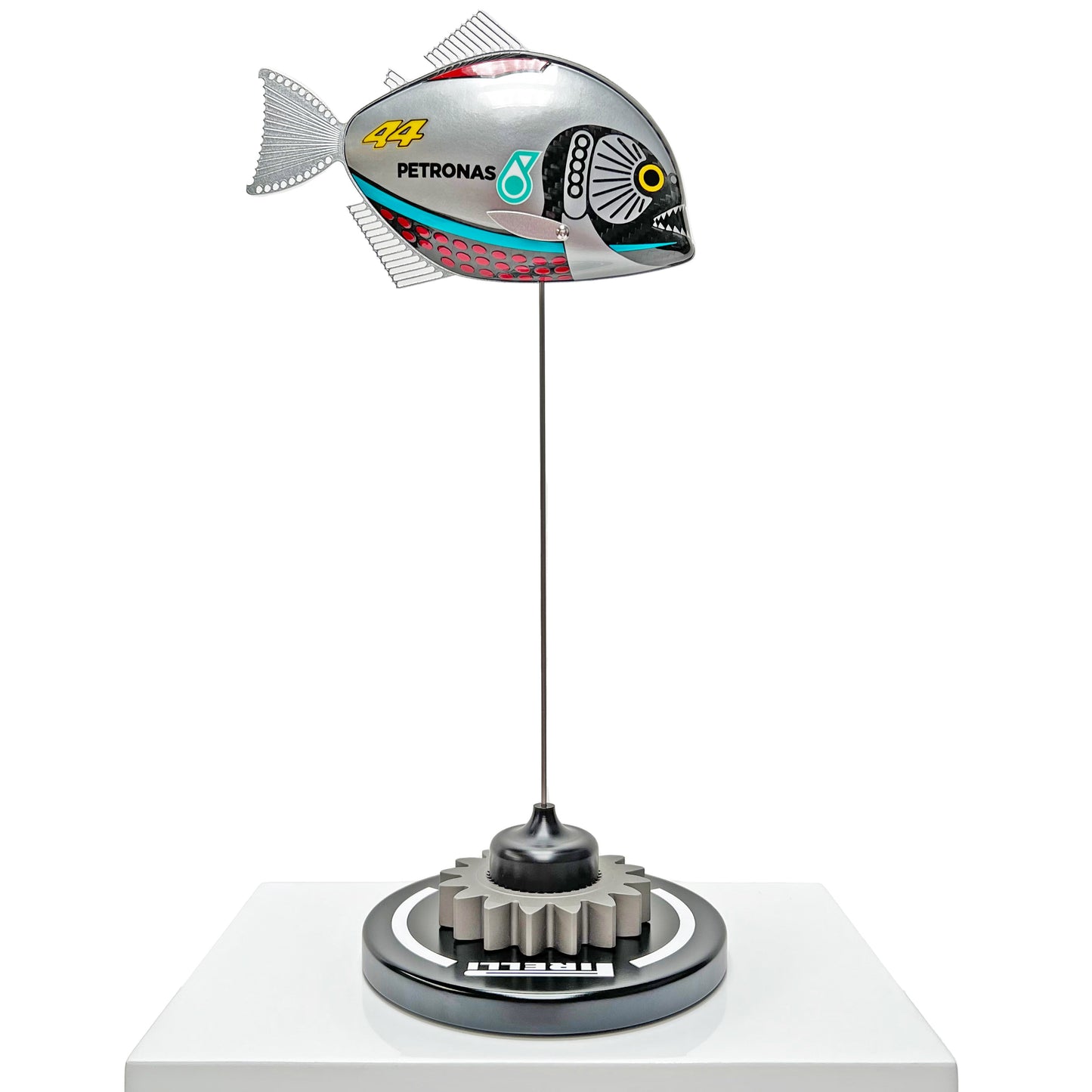 Carbon fibre piranha sculpture with Mercedes livery on a black base with F1 gear
