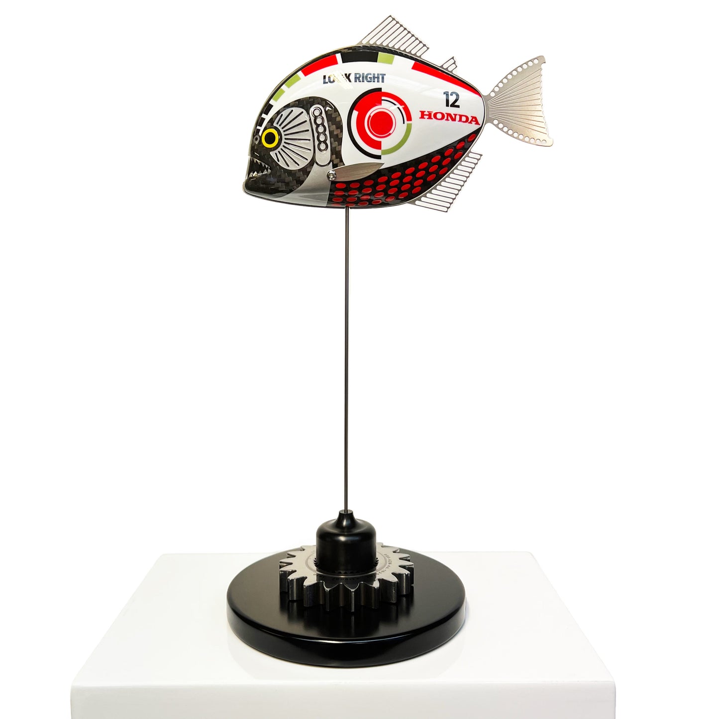 Carbon fibre baby piranha sculpture with BAR Honda F1 livery on a black base with F1 gear