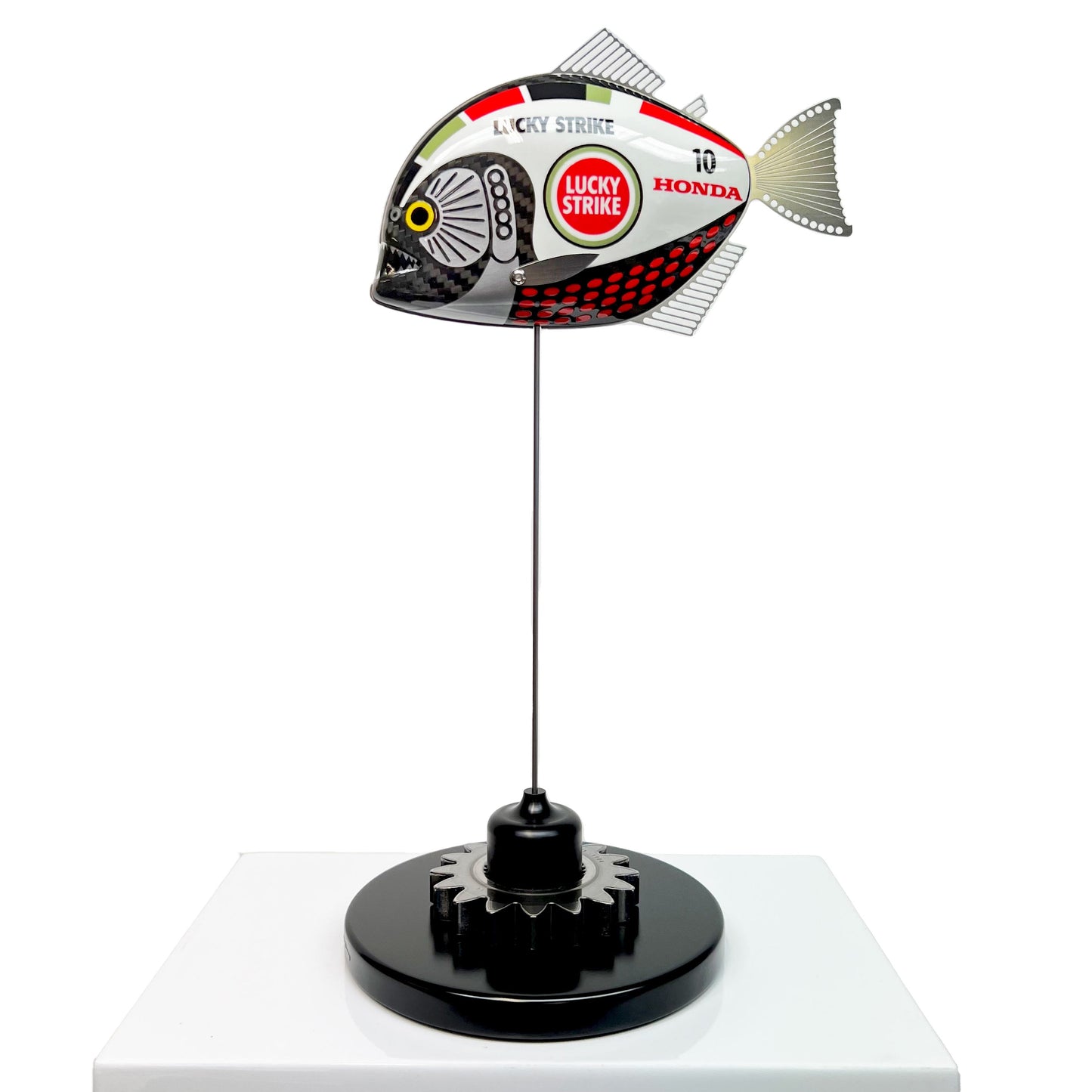 Carbon fibre baby piranha sculpture with BAR Honda F1 livery on a black base with F1 gear