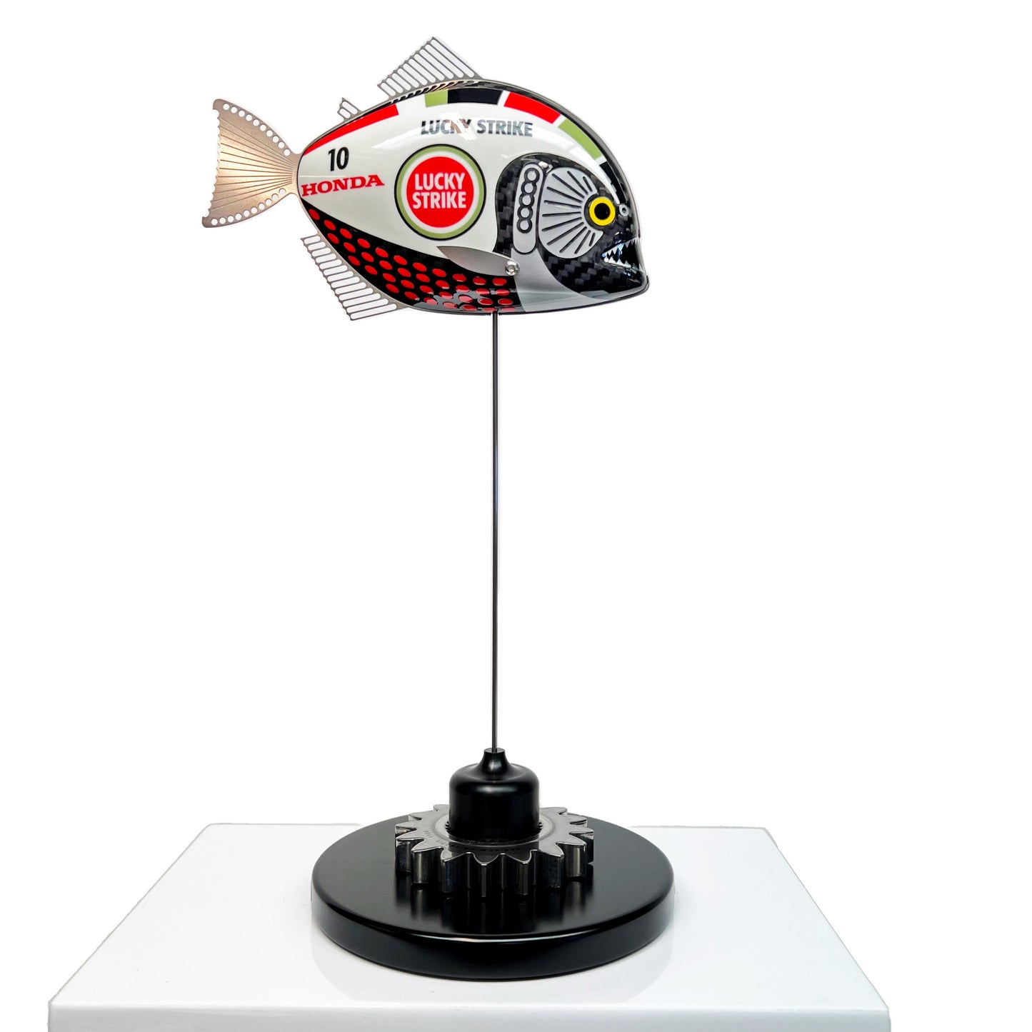 Carbon fibre baby piranha sculpture with BAR Honda F1 livery on a black base with F1 gear