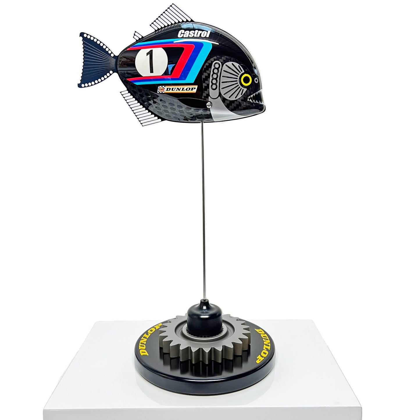 Carbon fibre baby piranha sculpture with BMW livery on a black base with F1 gear