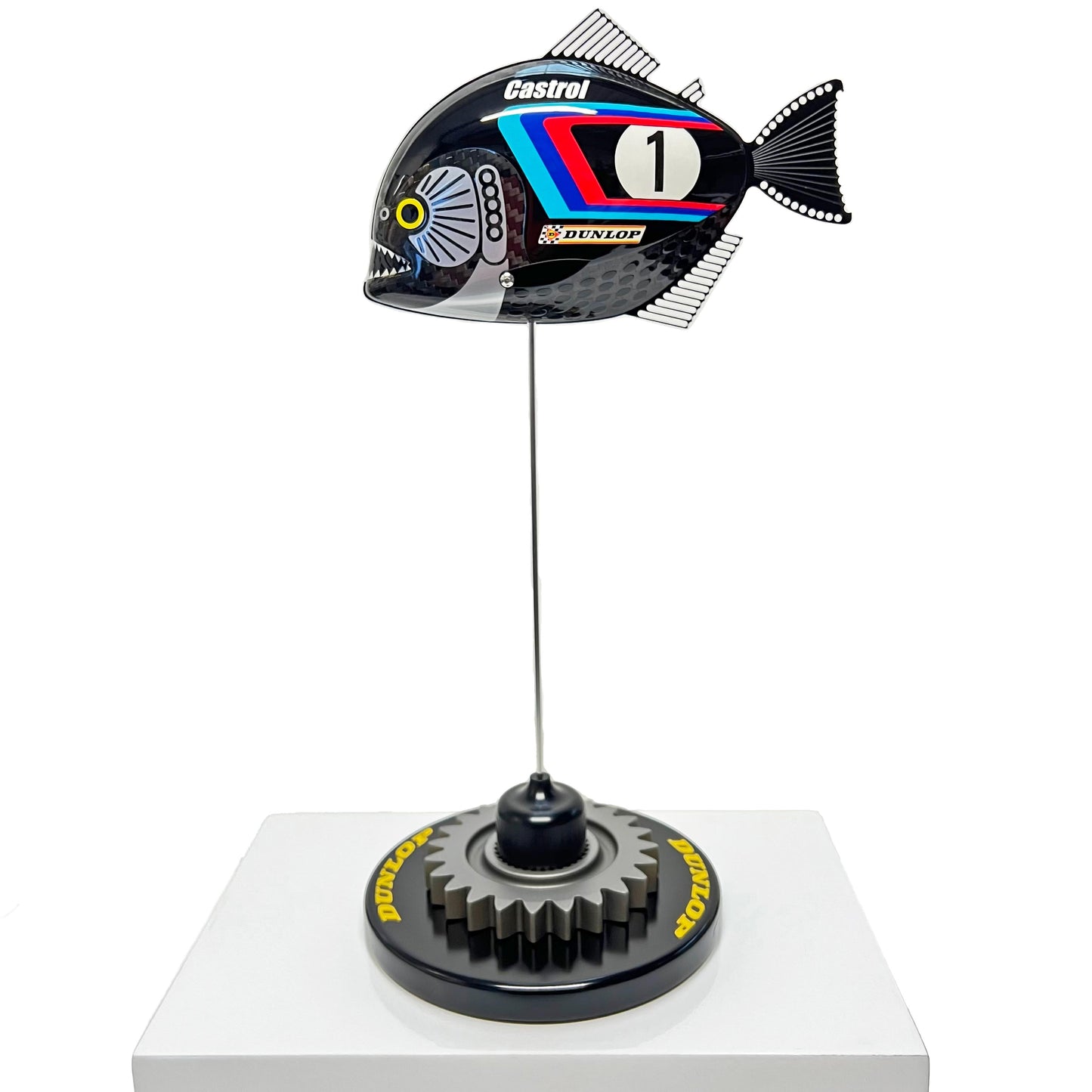 Carbon fibre baby piranha sculpture with BMW livery on a black base with F1 gear