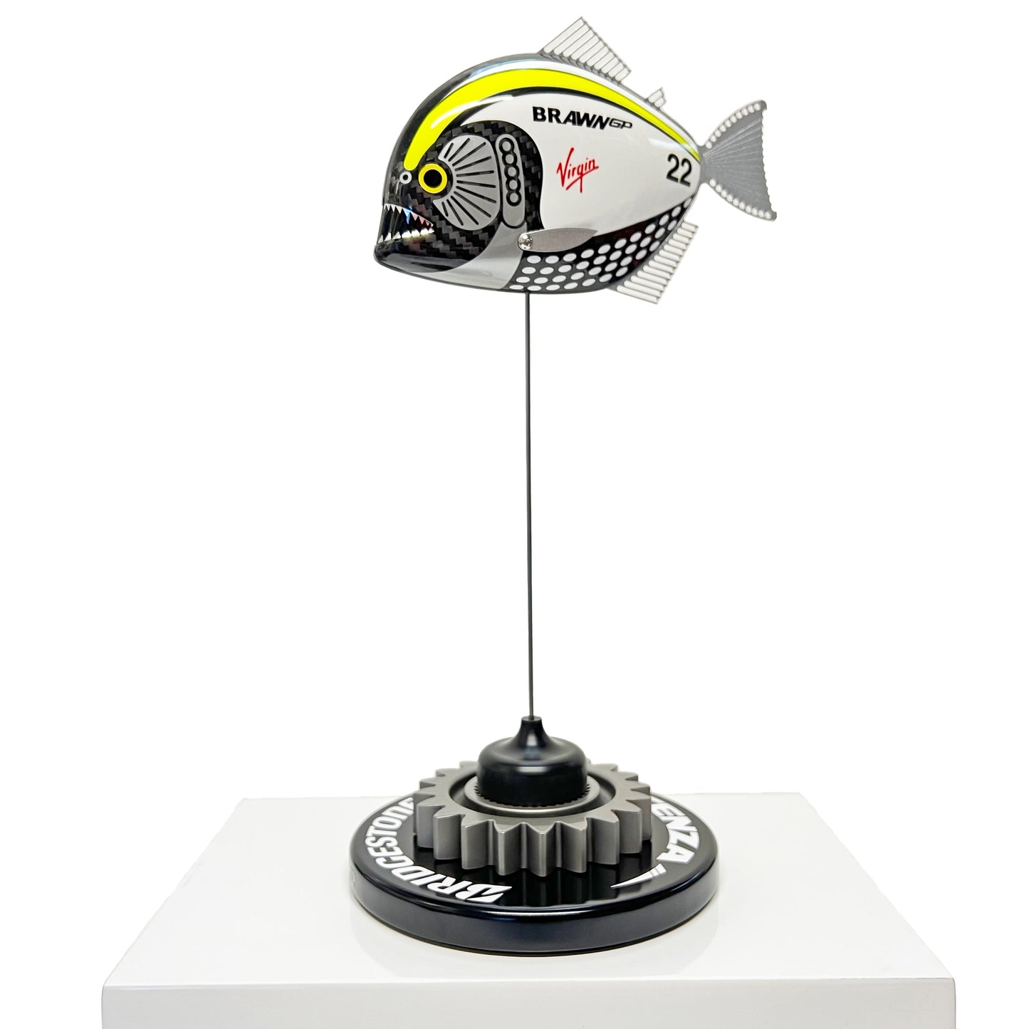 Carbon fibre piranha sculpture with Brawn GP livery on a black base with F1 gear