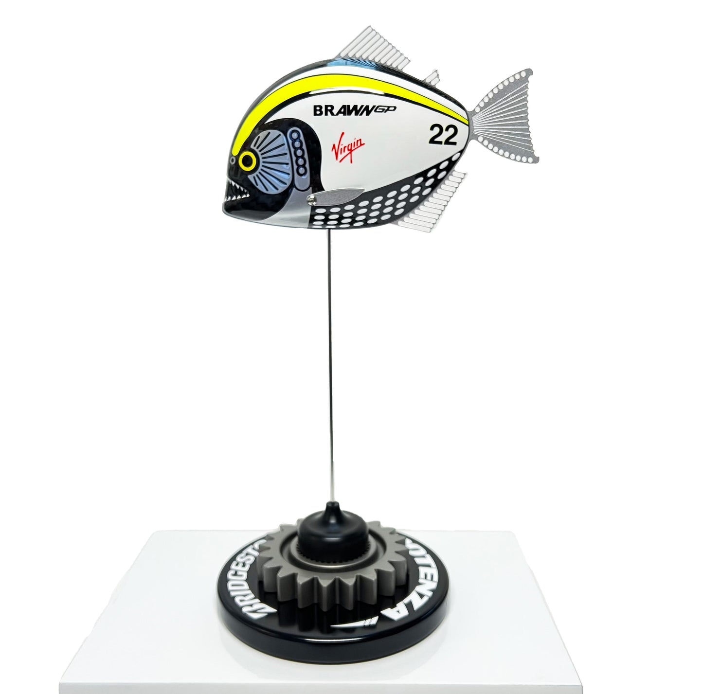 Carbon fibre piranha sculpture with Brawn GP livery on a black base with F1 gear