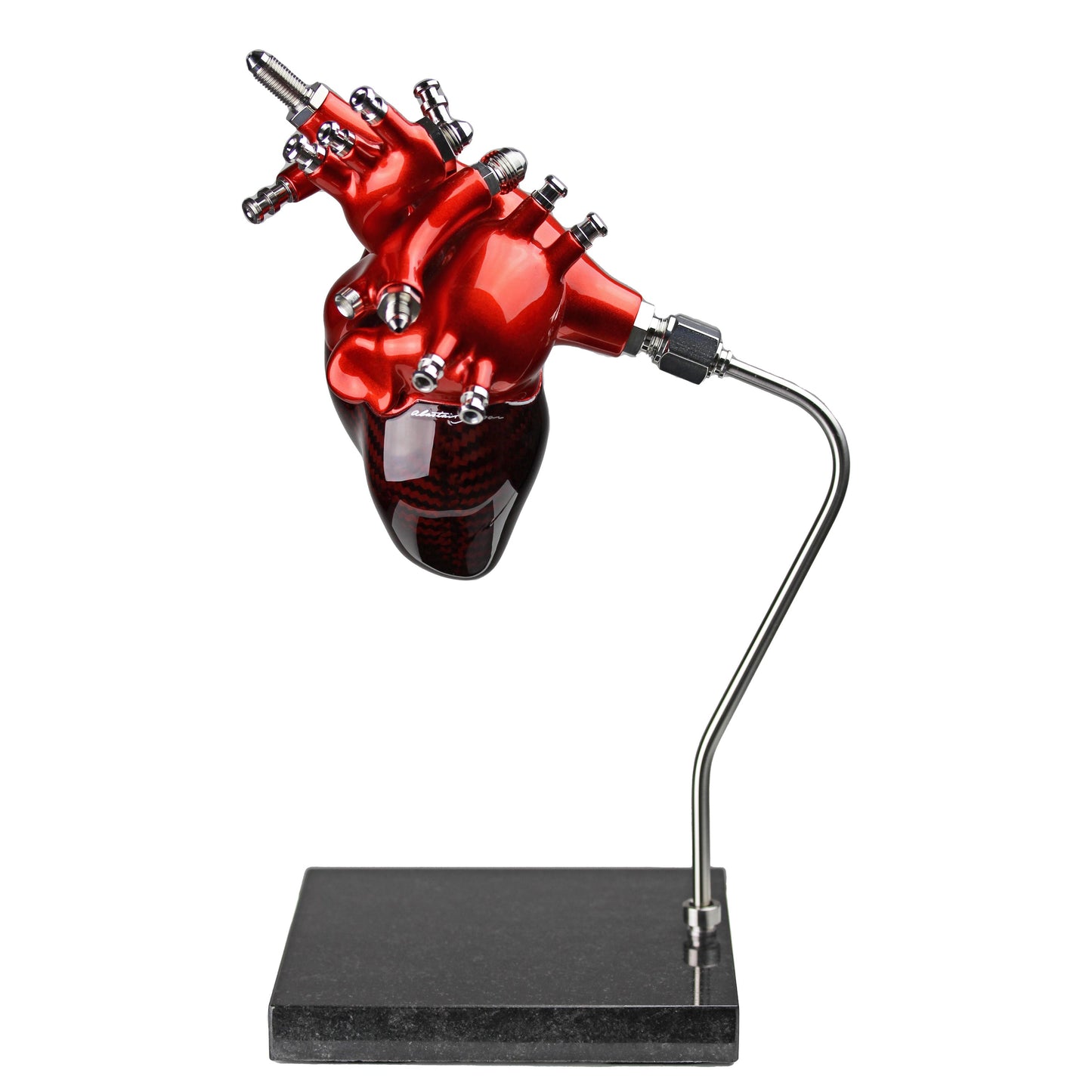 Carbon fibre Human Heart with red tint and red painted detail on a granite base