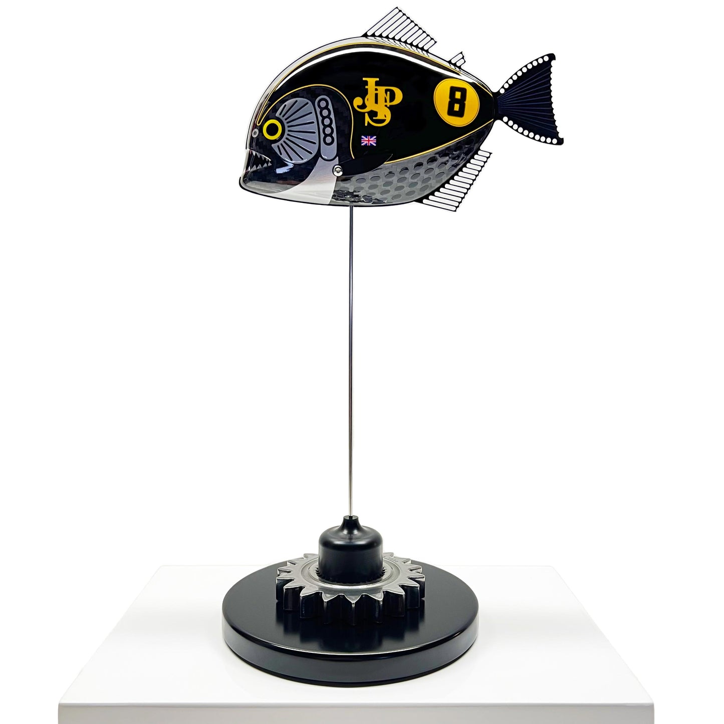 Carbon fibre Piranha sculpture with JPS livery on a black base with F1 gear