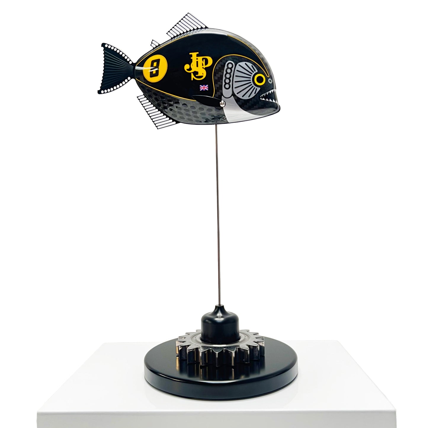 Carbon fibre Piranha sculpture with JPS livery on a black base with F1 gear