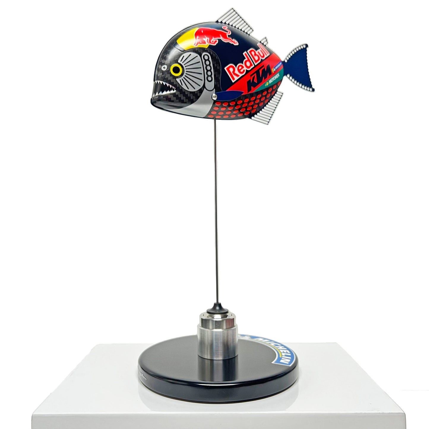 Carbon fibre Piranha sculpture with KTM Redbull livery on a black base with F1 part