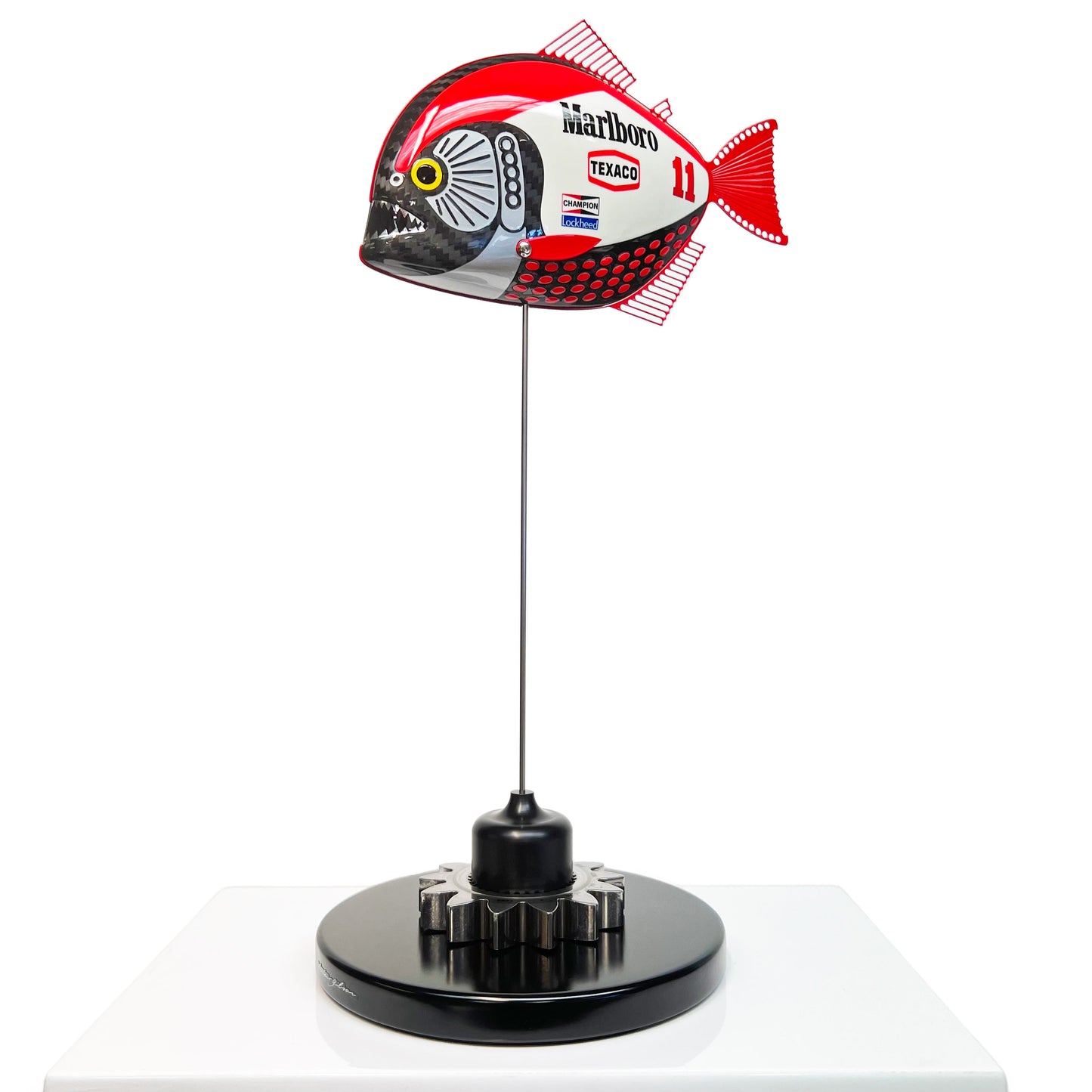 Carbon fibre Piranha sculpture with Marlboro McLaren livery on a black base with F1 gear