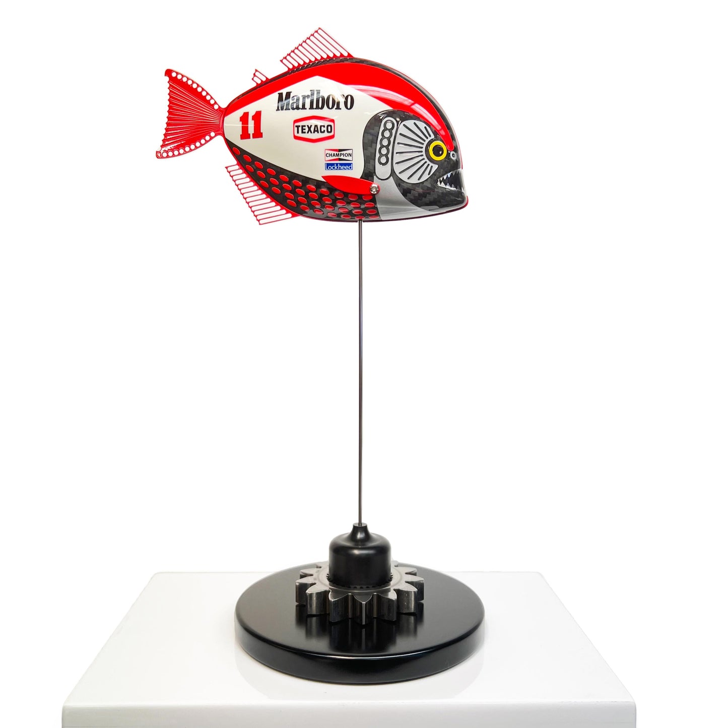Carbon fibre Piranha sculpture with Marlboro McLaren livery on a black base with F1 gear