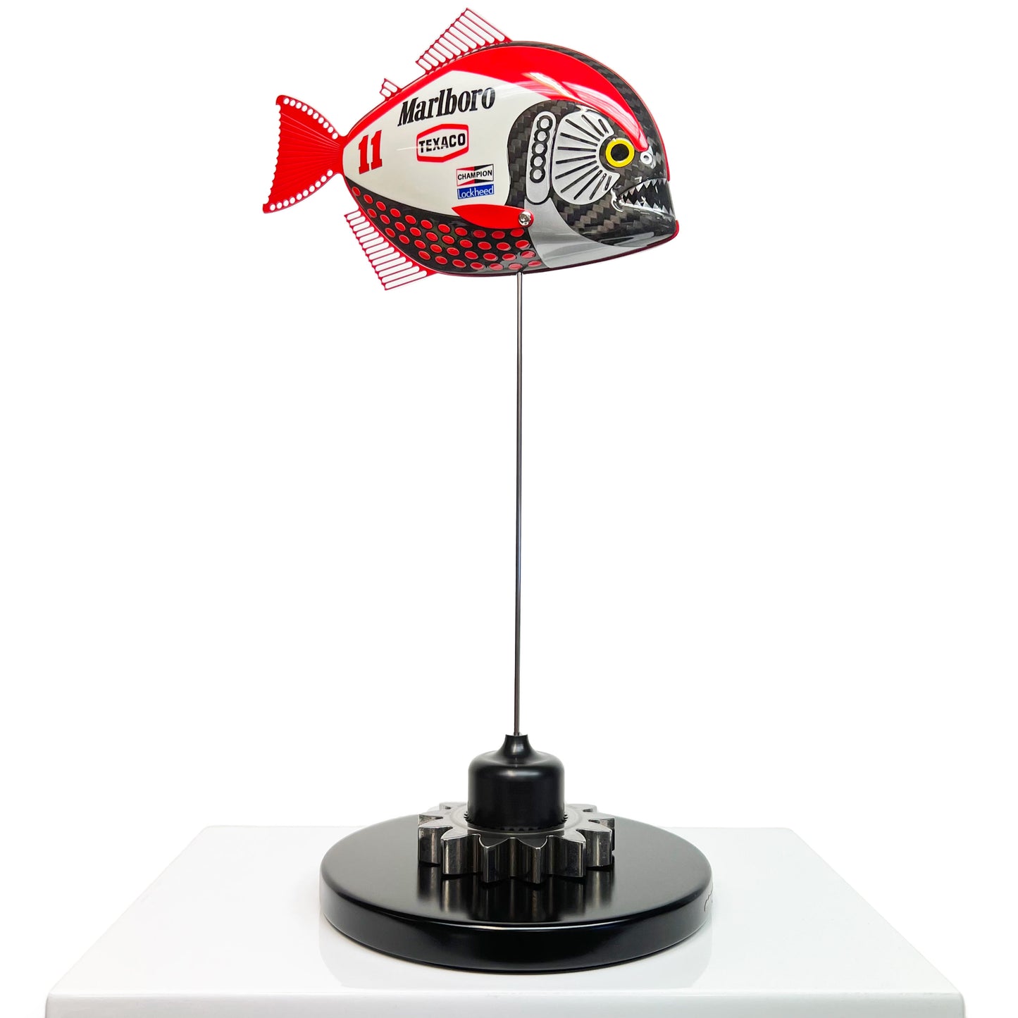 Carbon fibre Piranha sculpture with Marlboro McLaren livery on a black base with F1 gear