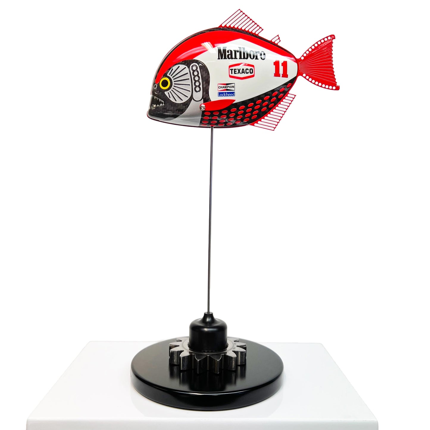 Carbon fibre Piranha sculpture with Marlboro McLaren livery on a black base with F1 gear