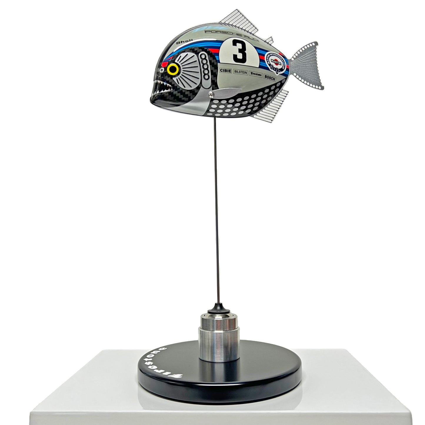 Carbon fibre Piranha sculpture with Martini Porsche livery on a black base with F1 parts