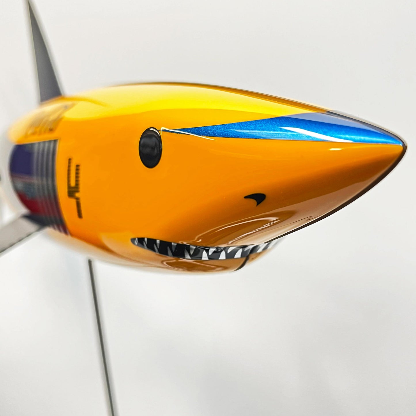 Carbon fibre Mako Shark pup with McLaren livery and black fins on a black base with F1 parts