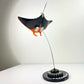 Gulf Ford inspired carbon fibre manta ray sculpture on a stand with white background