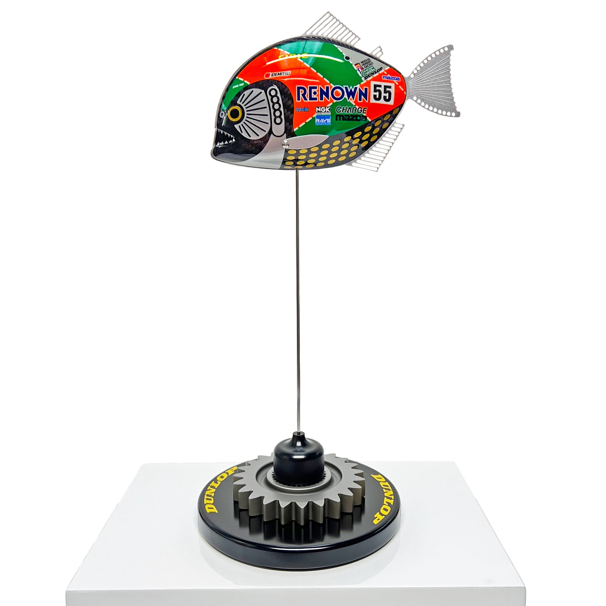 Carbon fibre Piranha sculpture with Mazda 787B livery on a black base with F1 gear
