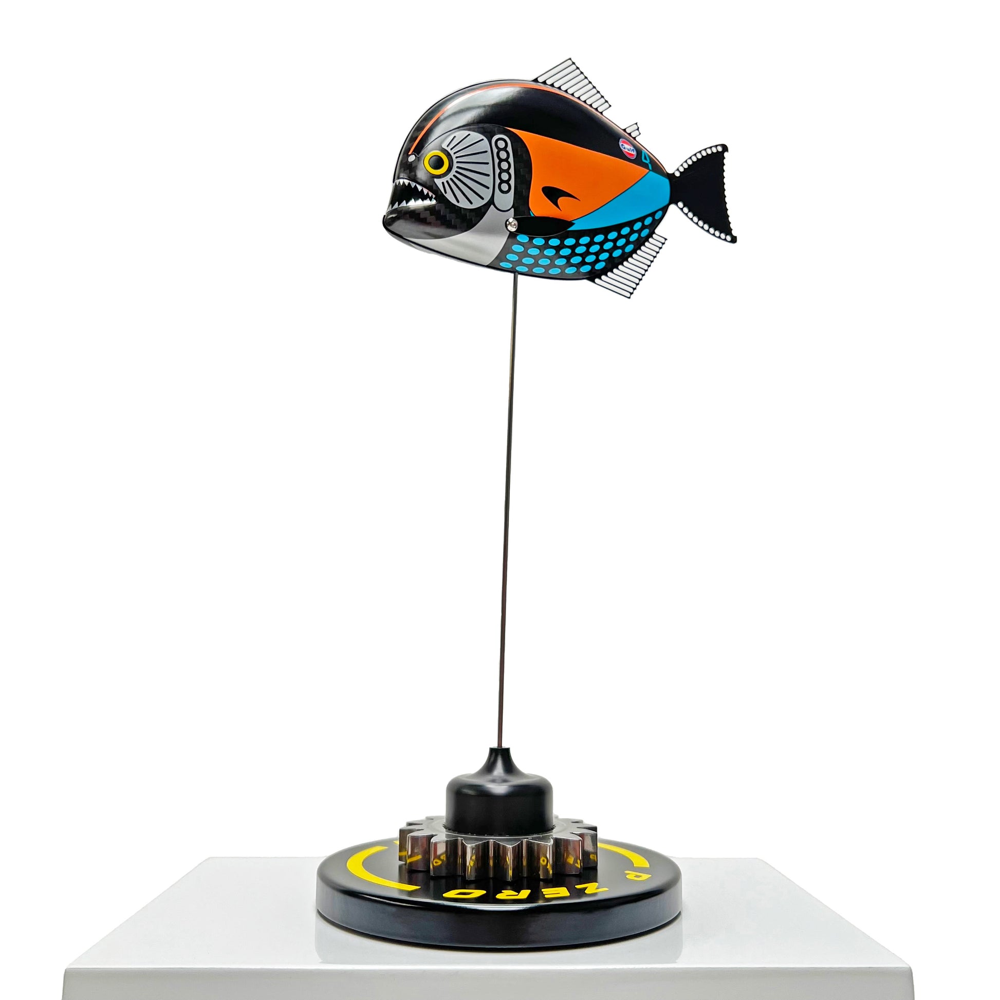 Carbon fibre Piranha sculpture with McLaren livery on a black base with F1 gear