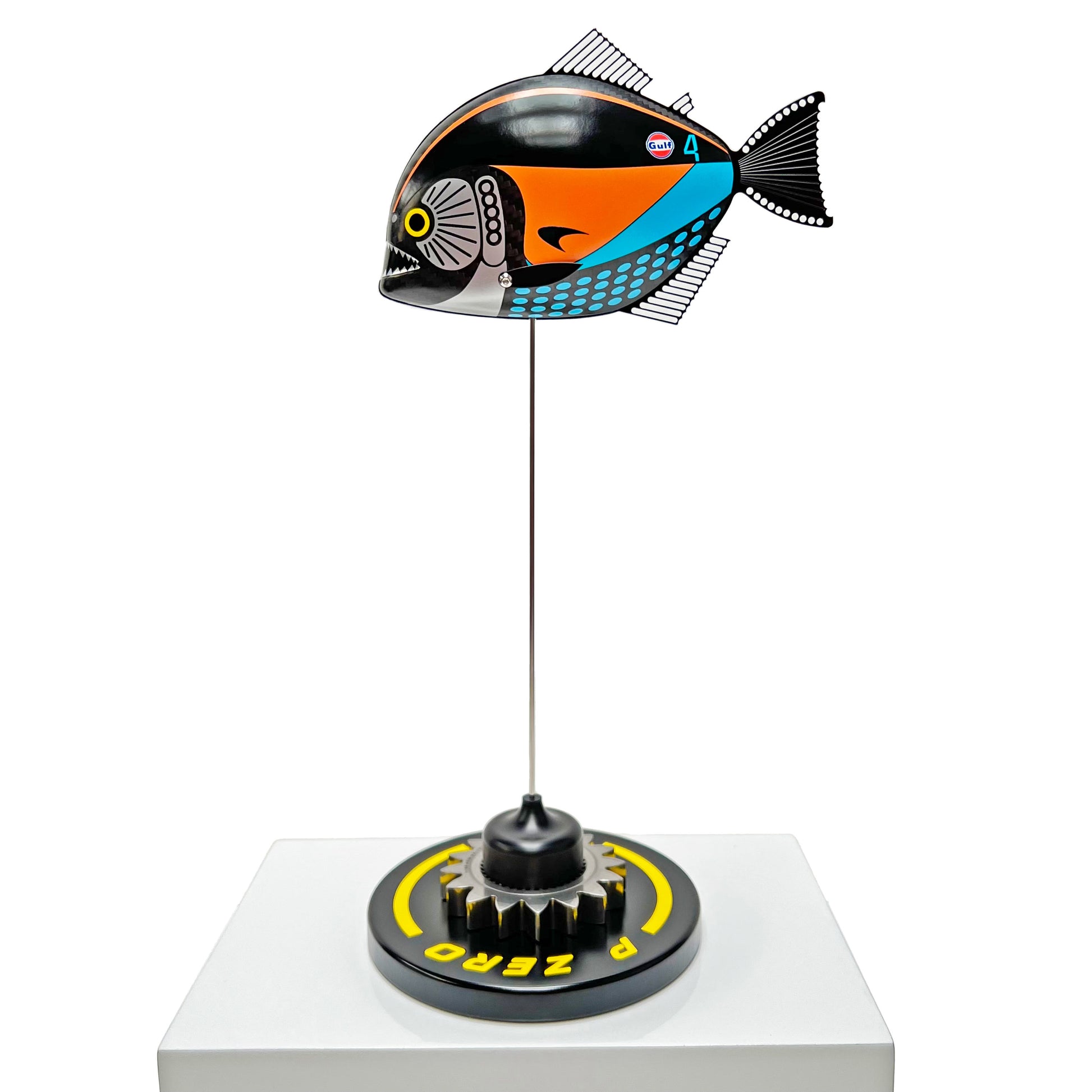 Carbon fibre Piranha sculpture with McLaren livery on a black base with F1 gear