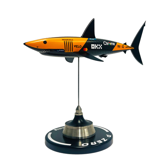 Carbon fibre sculpture of a shark with McLaren F1 branding on a white background