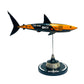 Carbon fibre sculpture of a shark with McLaren F1 branding on a white background