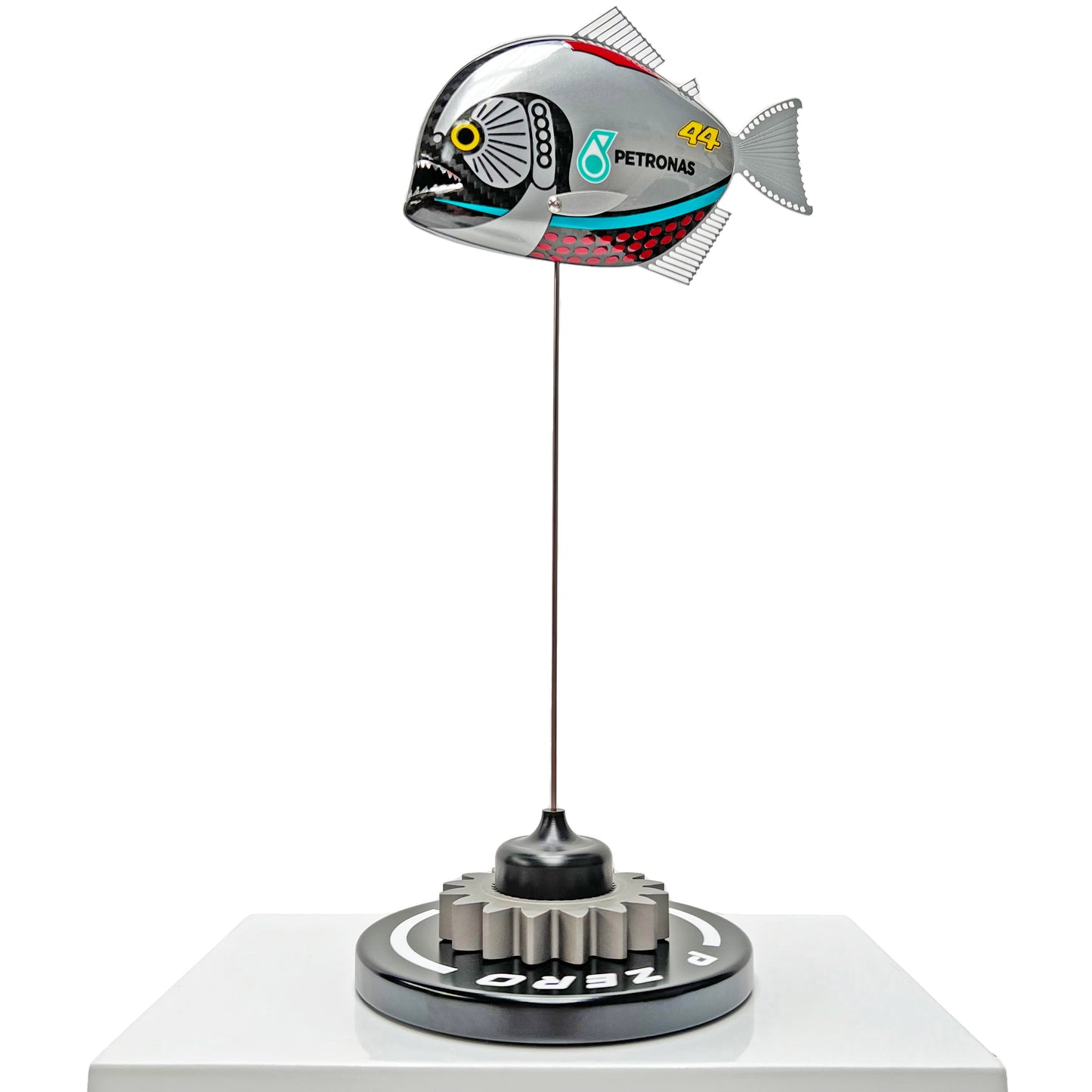 Carbon fibre piranha sculpture with Mercedes livery on a black base with F1 gear