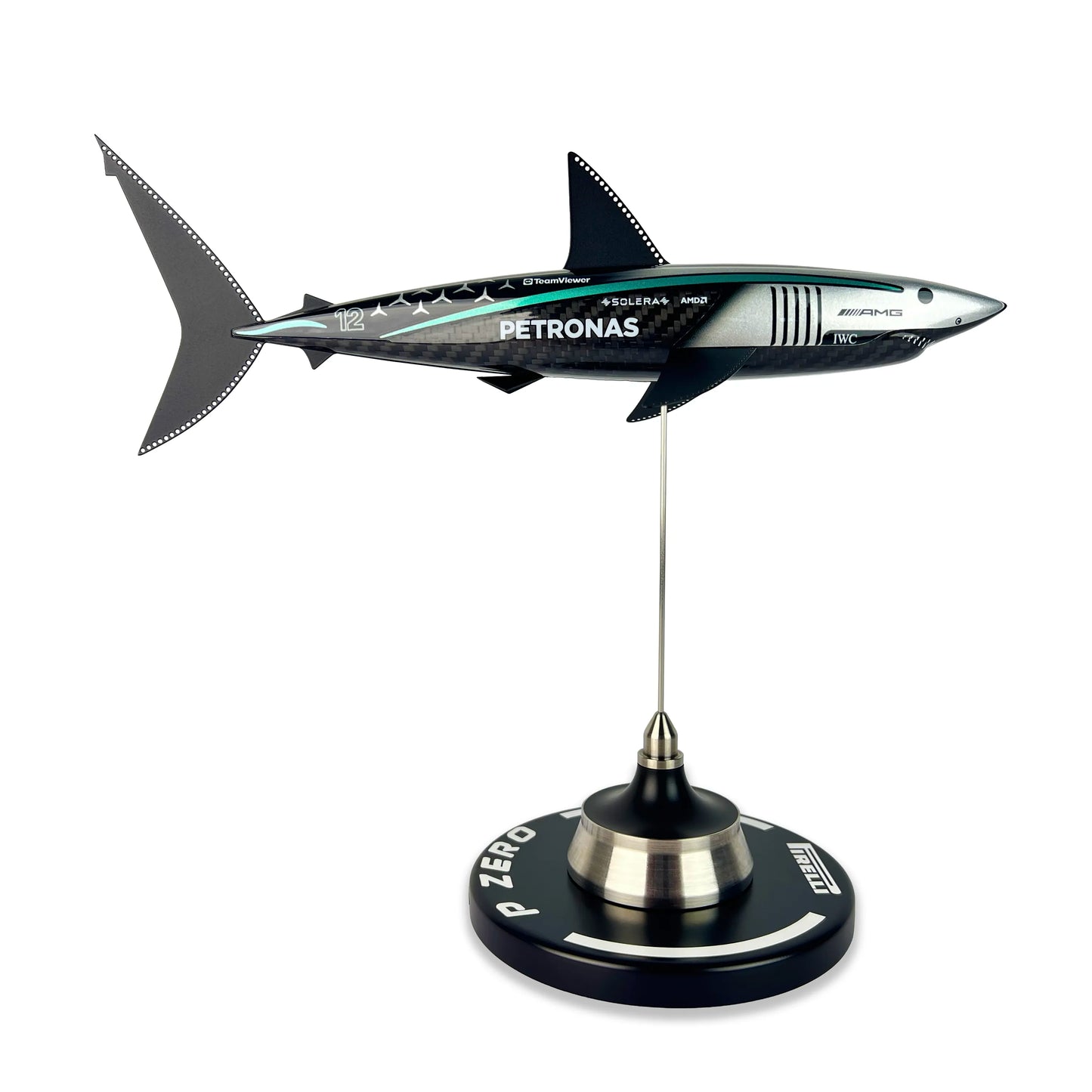Carbon Fibre Sculpture of a shark with Mercedes racing livery on a stand against a white background