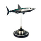 Carbon Fibre Sculpture of a shark with Mercedes racing livery on a stand against a white background