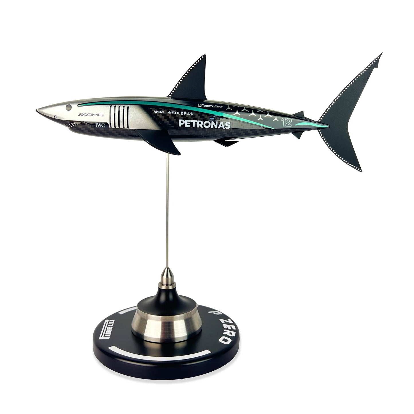 Carbon Fibre Sculpture of a shark with Mercedes racing livery on a stand against a white background