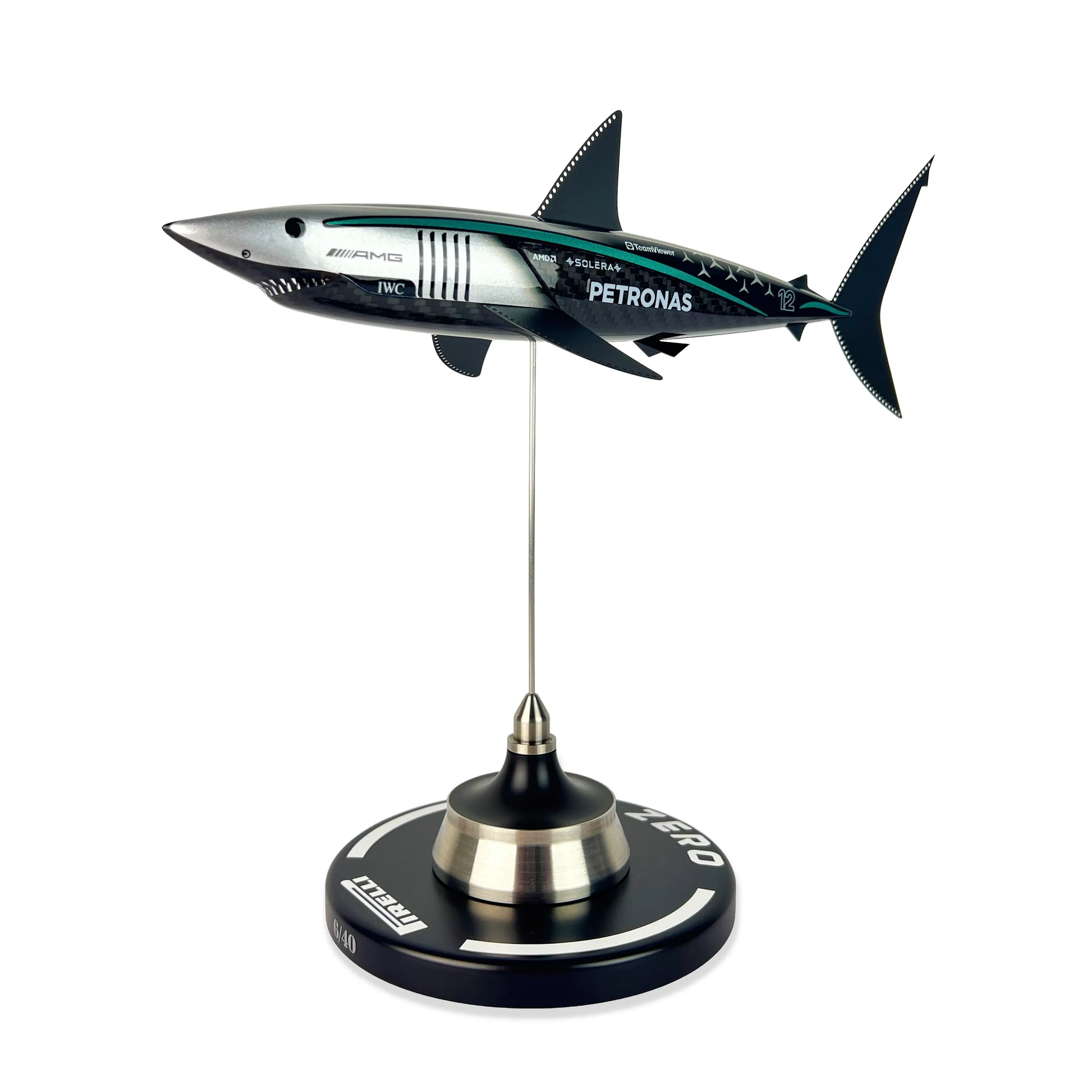 Carbon Fibre Sculpture of a shark with Mercedes racing livery on a stand against a white background