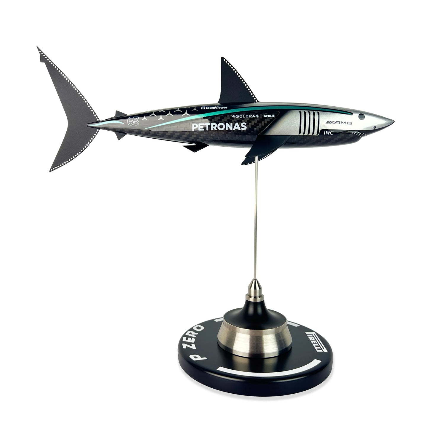 Carbon Fibre Sculpture of a shark with Mercedes racing livery on a stand against a white background