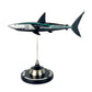 Carbon Fibre Sculpture of a shark with Mercedes racing livery on a stand against a white background