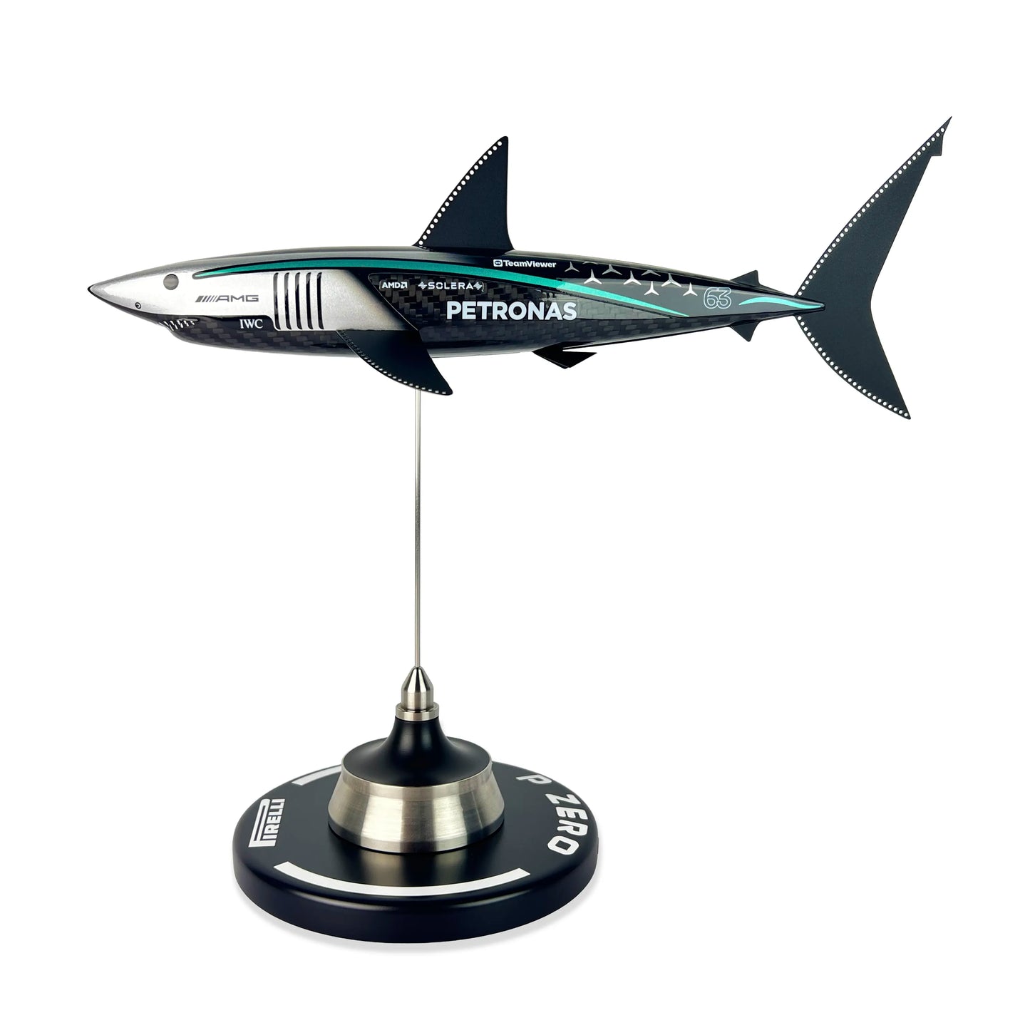 Carbon Fibre Sculpture of a shark with Mercedes racing livery on a stand against a white background