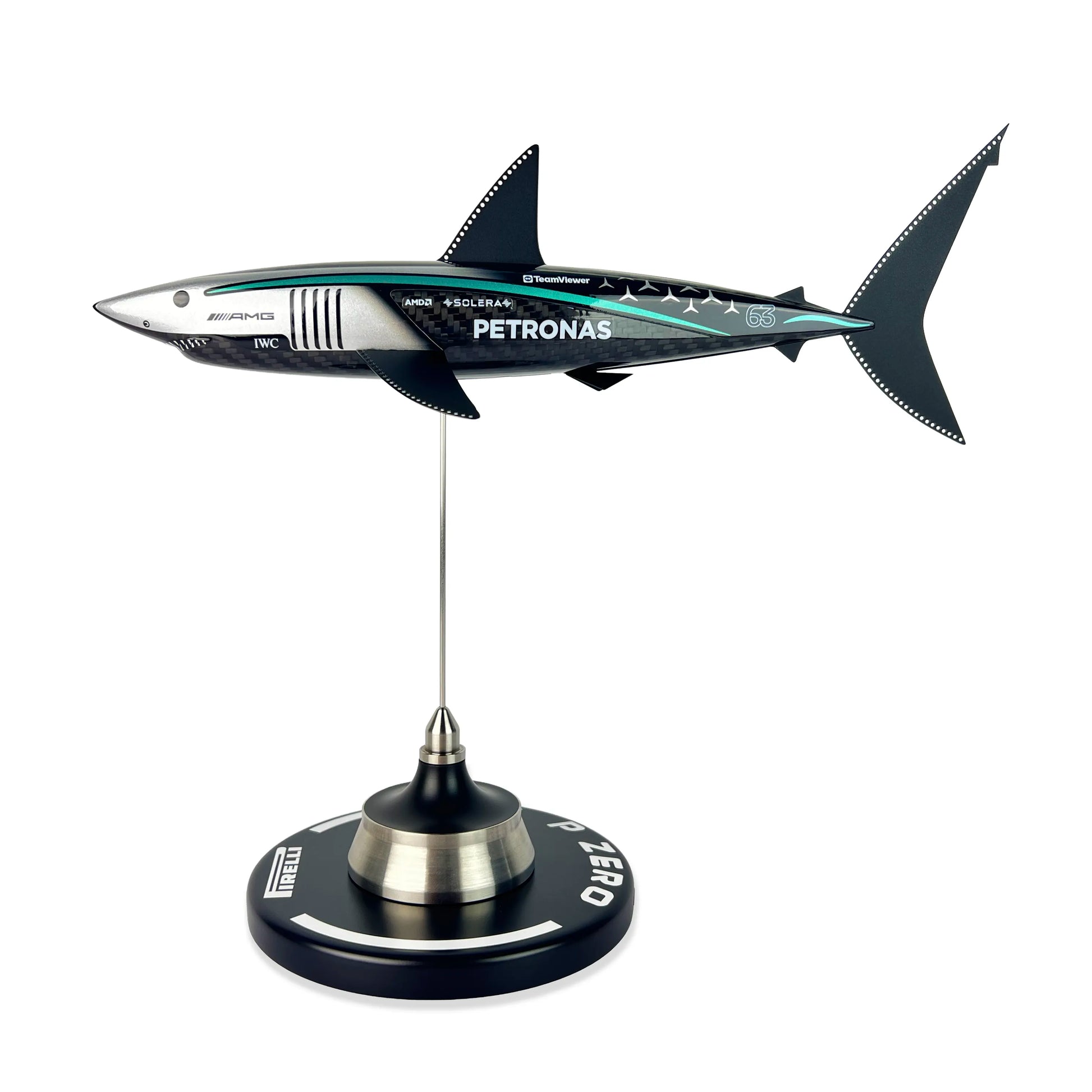 Carbon Fibre Sculpture of a shark with Mercedes racing livery on a stand against a white background