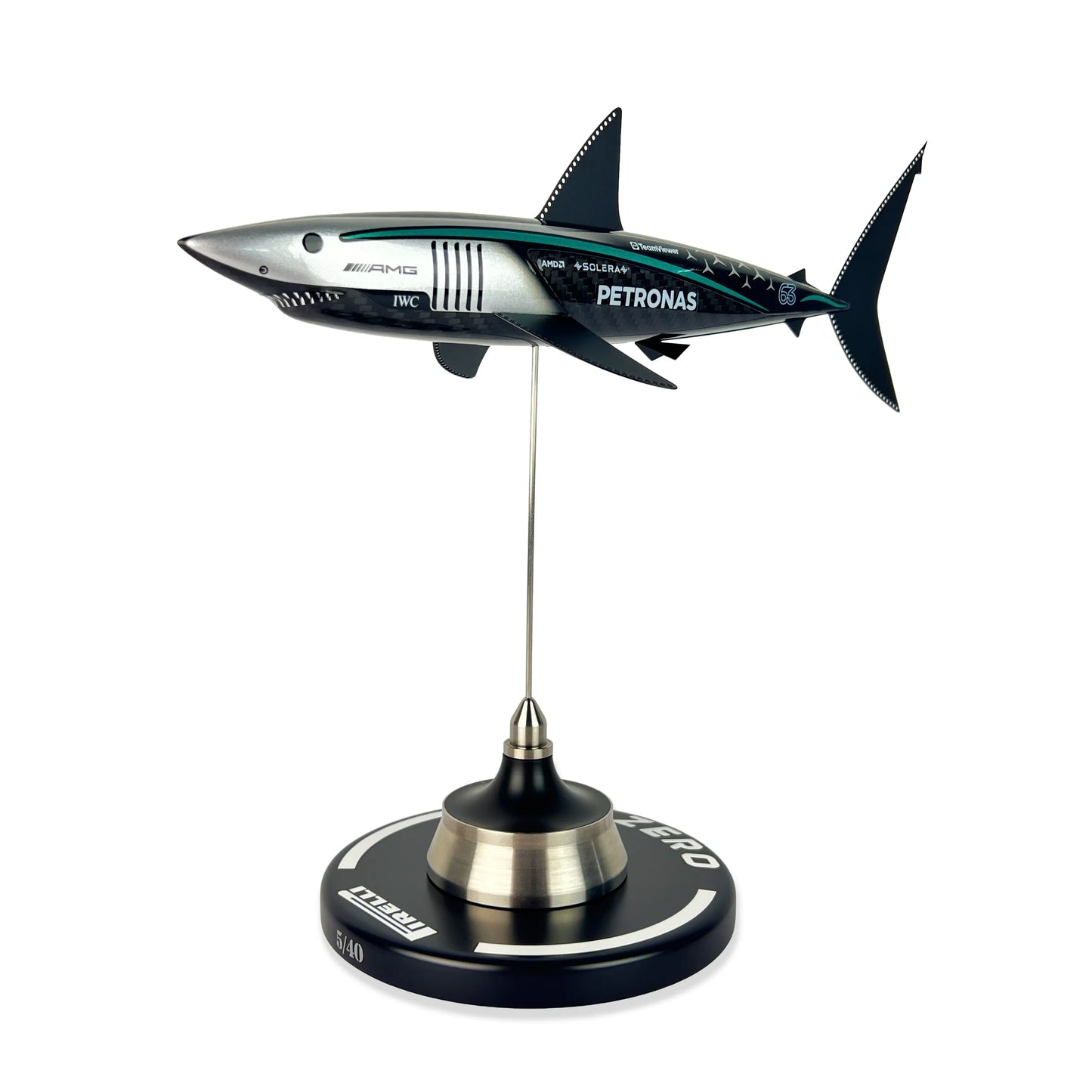 Carbon Fibre Sculpture of a shark with Mercedes racing livery on a stand against a white background